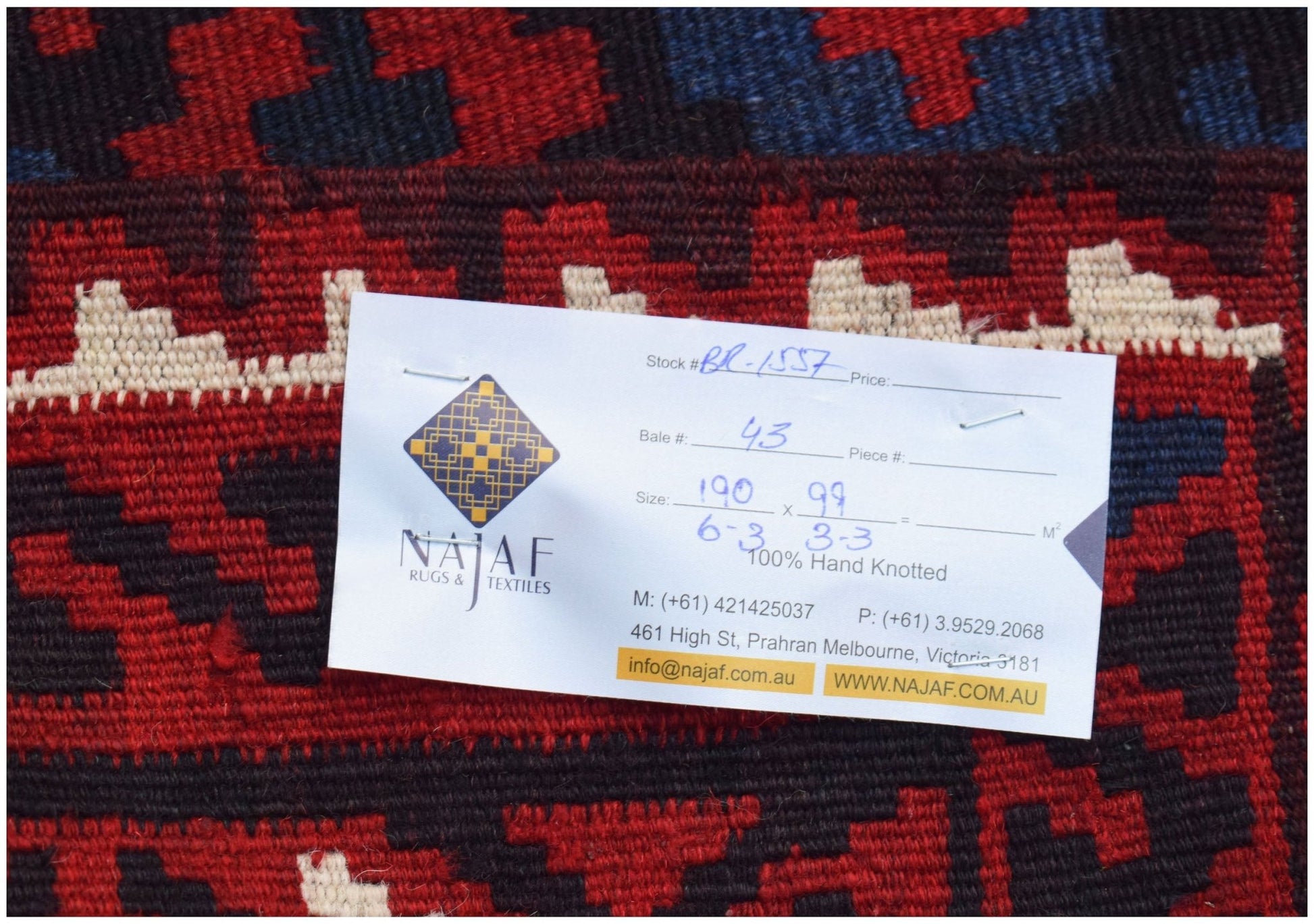 A handwoven Afghan Maimana Kilim featuring a geometric pattern in red, blue, and cream wool.