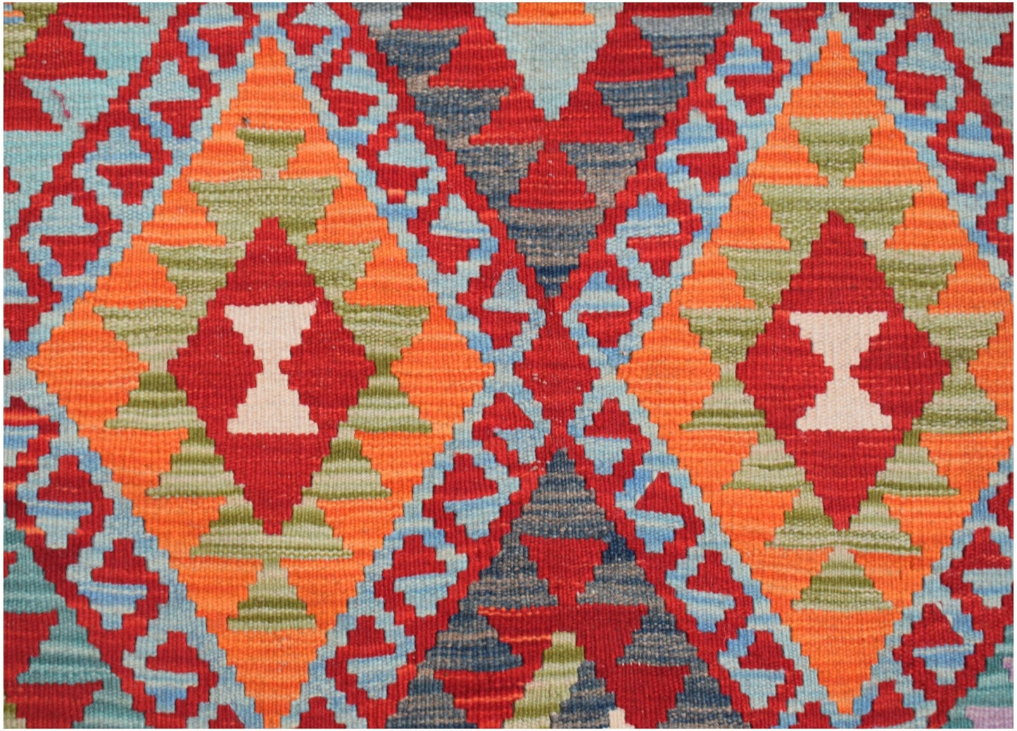 Handwoven Afghan Maimana kilim featuring a vibrant geometric diamond pattern in wool.