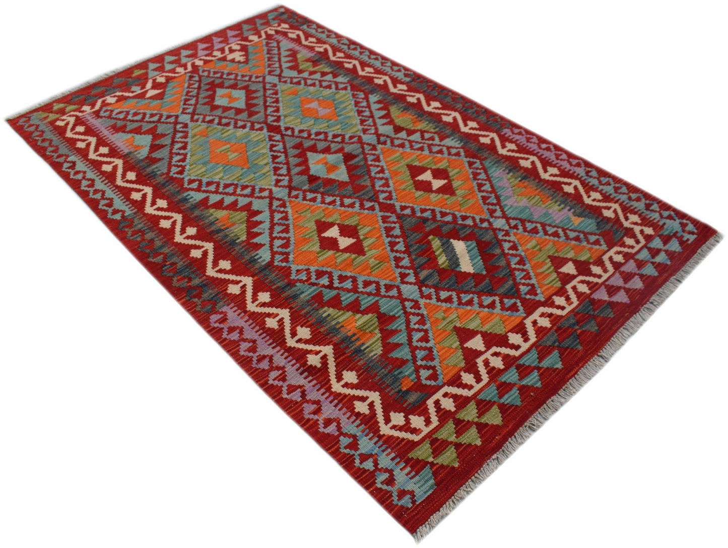 A rectangular Afghan Maimana kilim rug featuring a vibrant geometric pattern in wool.