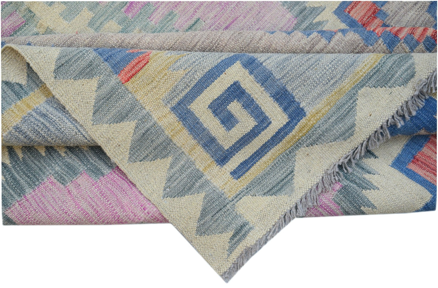 A handmade Afghan Maimana kilim rug featuring a geometric pattern in blue, pink, and cream wool.