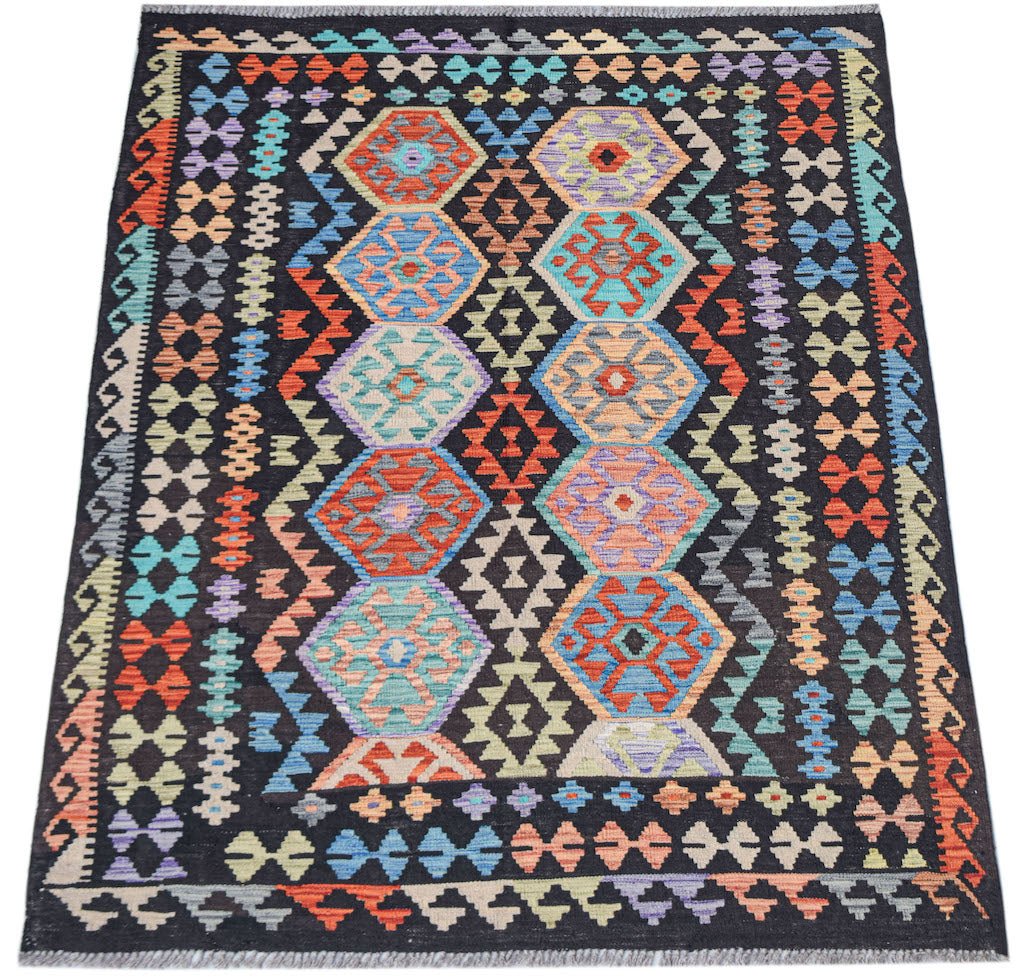 Afghan Maimana Kilim with geometric hexagonal patterns in vibrant colors on a black background.