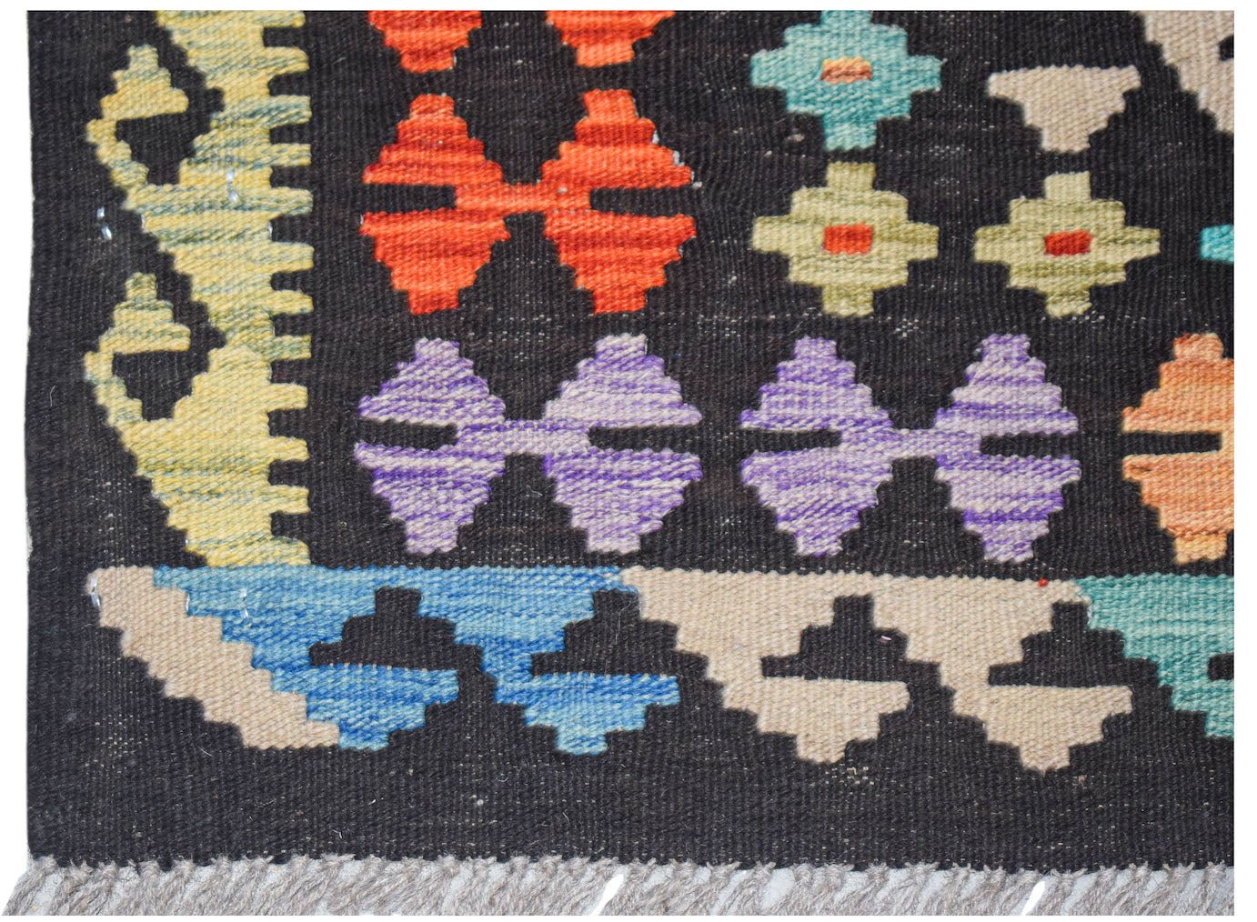 Afghan Maimana Kilim with geometric patterns in red, purple, blue, and yellow.