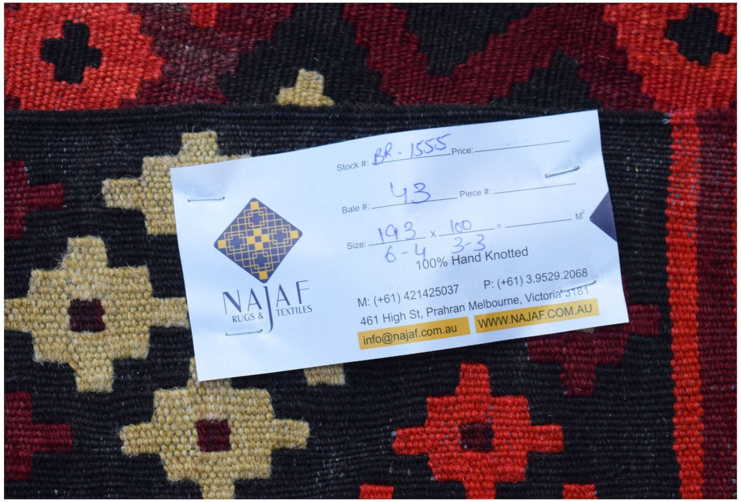 A flatwoven Afghan Maimana Kilim featuring a geometric pattern in red, black, and beige wool.