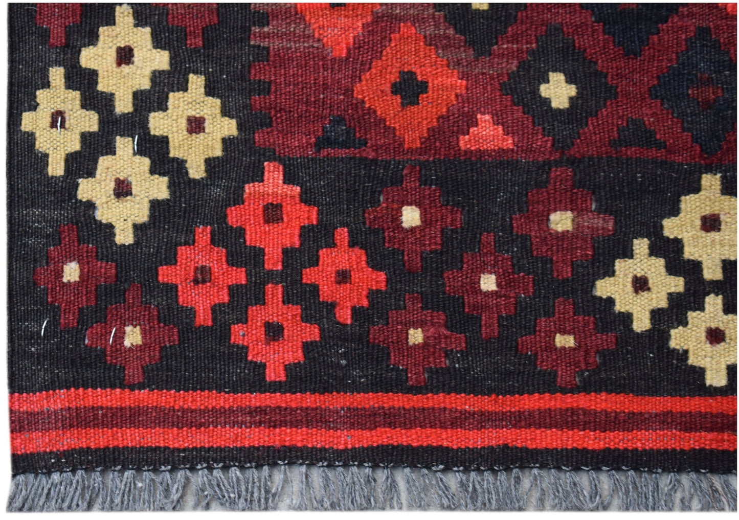 Handwoven Afghan Maimana kilim featuring geometric patterns in red, black, and cream wool.