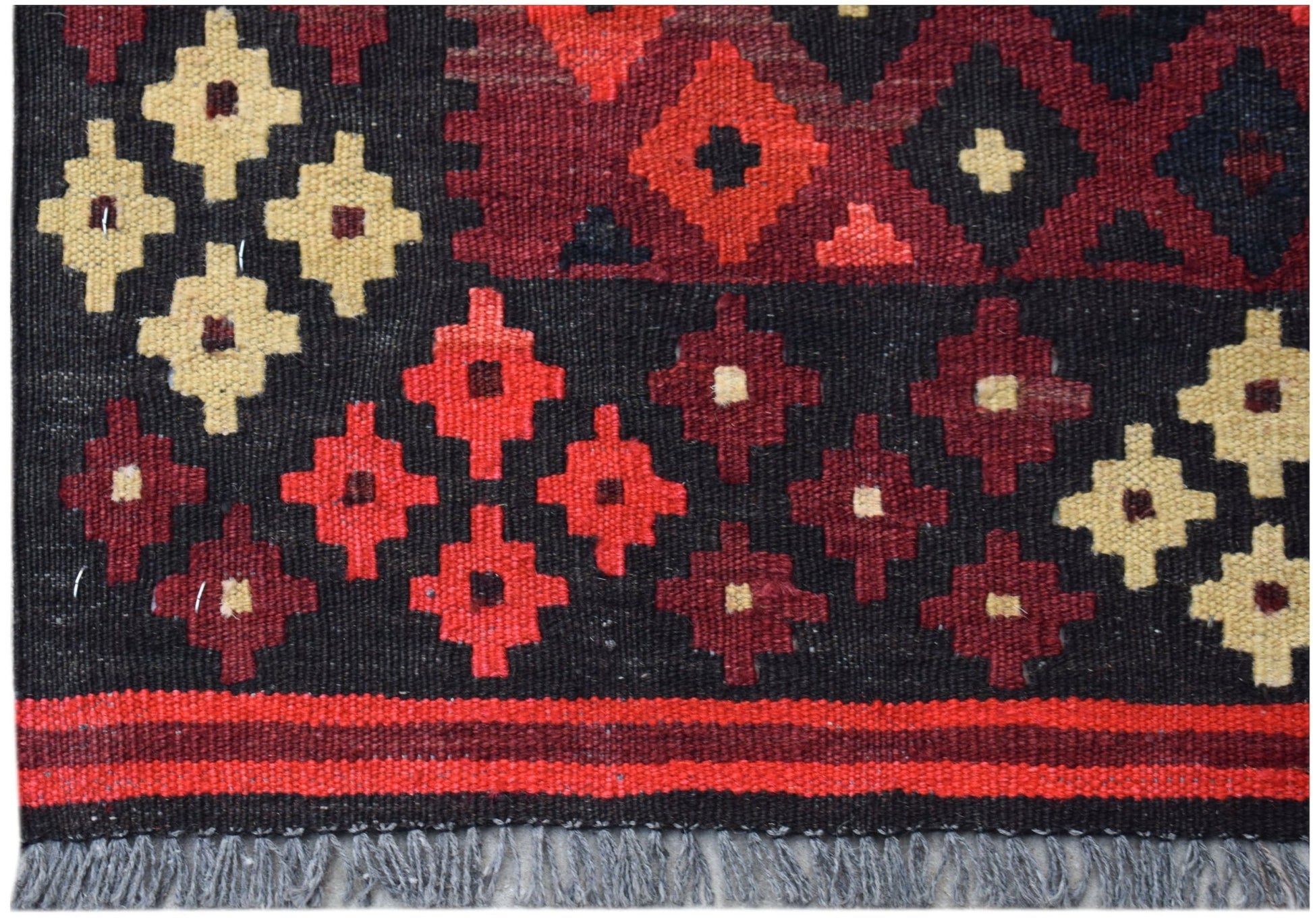 Handwoven Afghan Maimana kilim featuring geometric patterns in red, black, and cream wool.