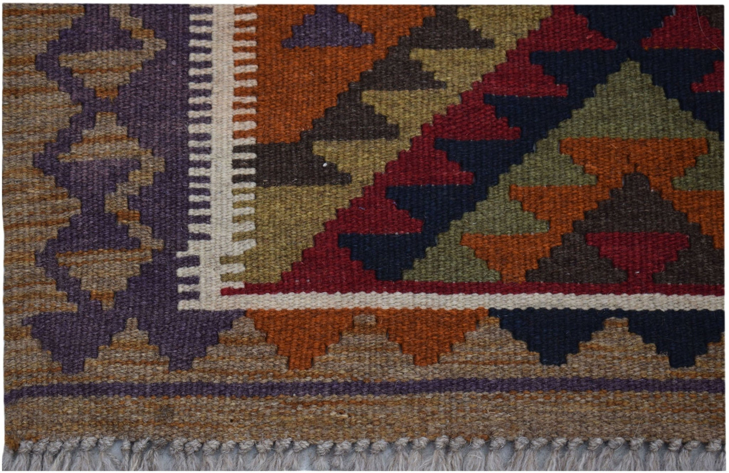Handwoven Afghan Maimana kilim rug featuring a geometric pattern in rich, earthy tones.