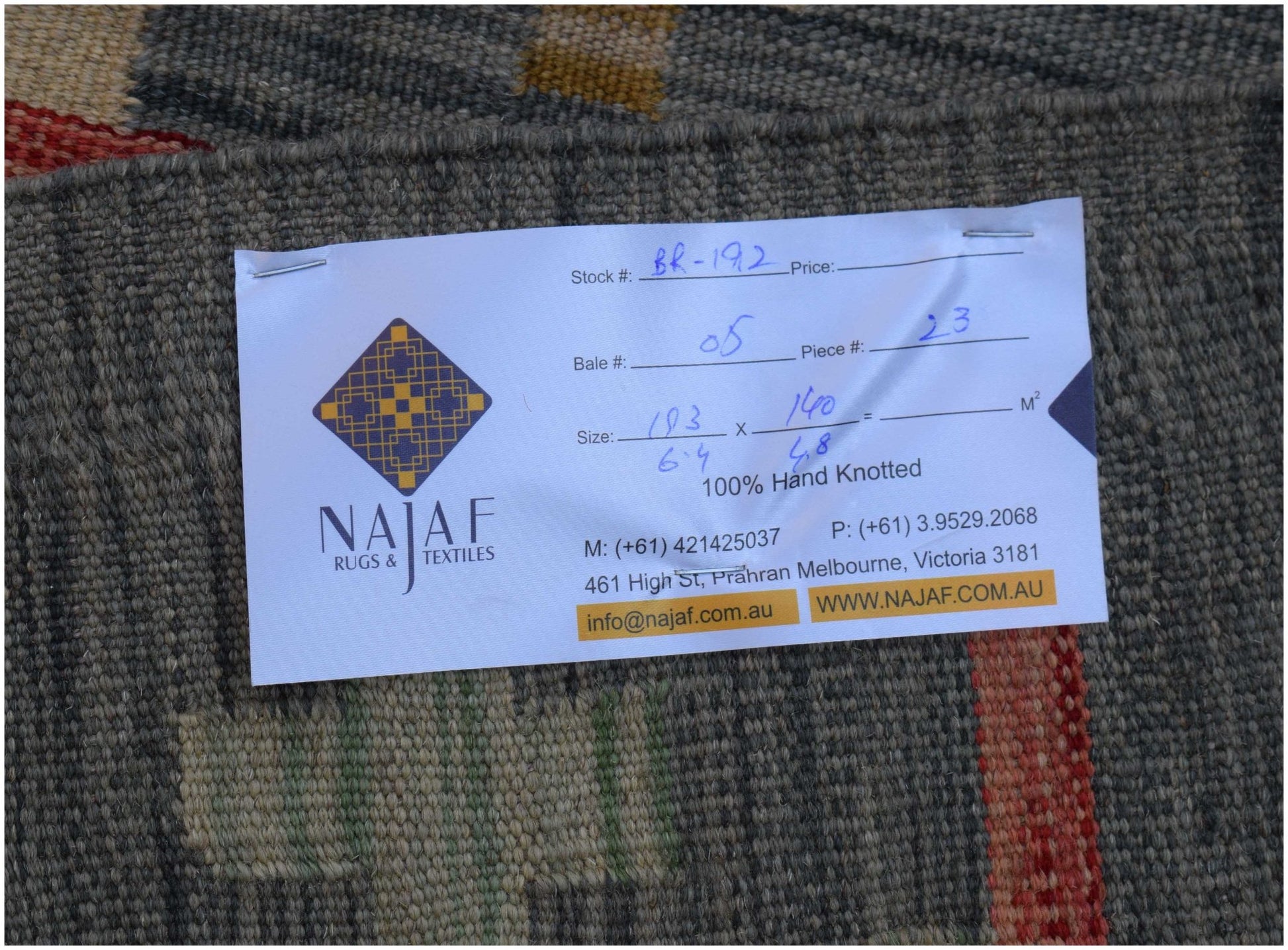 A handwoven Afghan Maimana Kilim rug featuring a textured grey surface with geometric patterns.