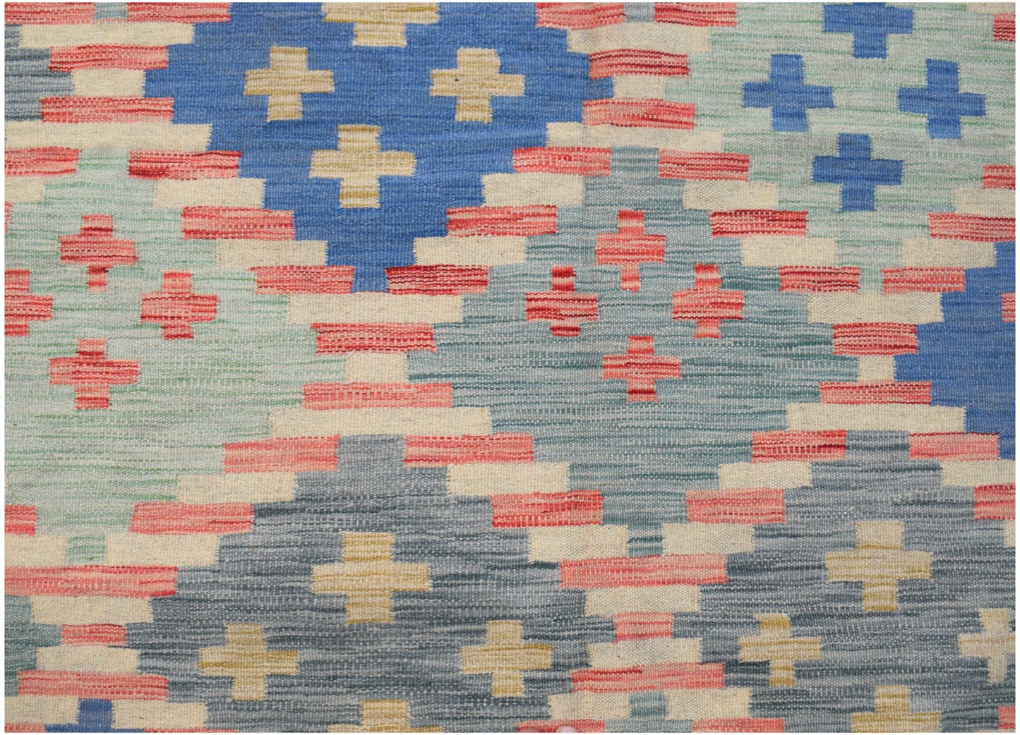 Handwoven Afghan Maimana kilim rug featuring a geometric pattern in blue, red, and cream tones.