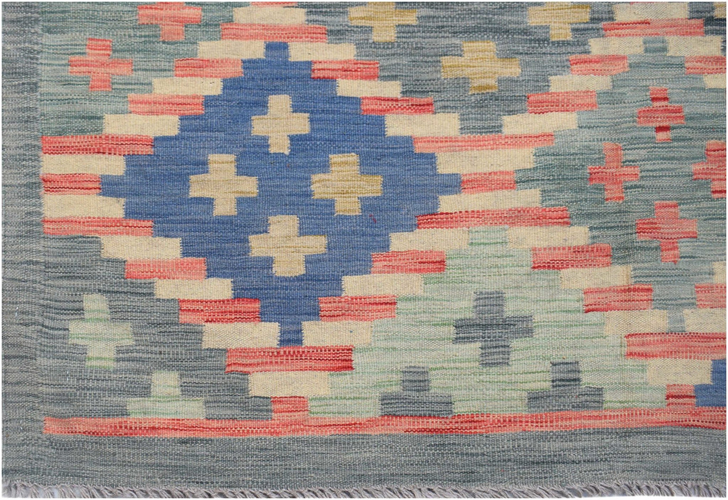 Handwoven Afghan Maimana kilim rug featuring a geometric diamond pattern in blue, red, and cream.