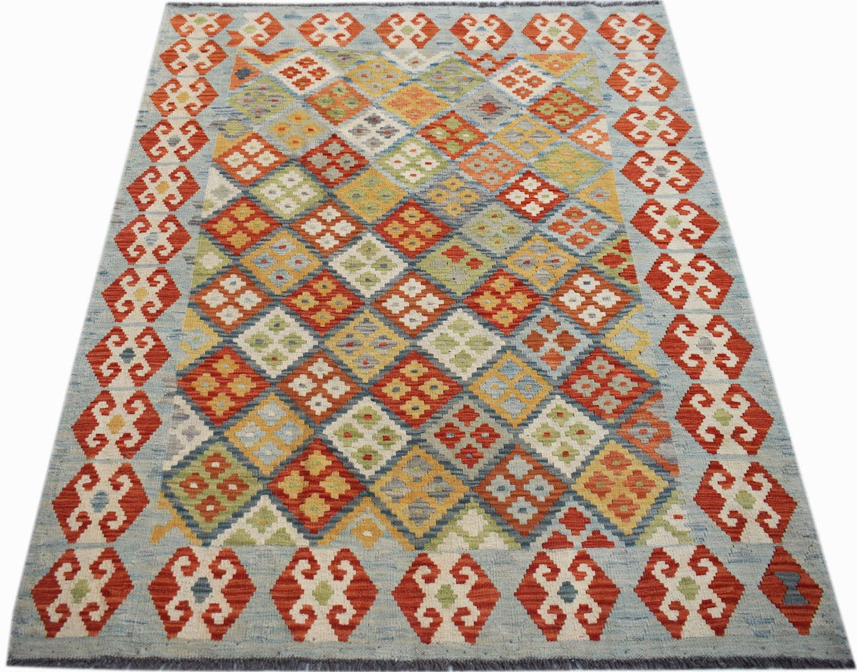 Handwoven Afghan Maimana kilim rug featuring a colorful geometric diamond pattern on a blue field.