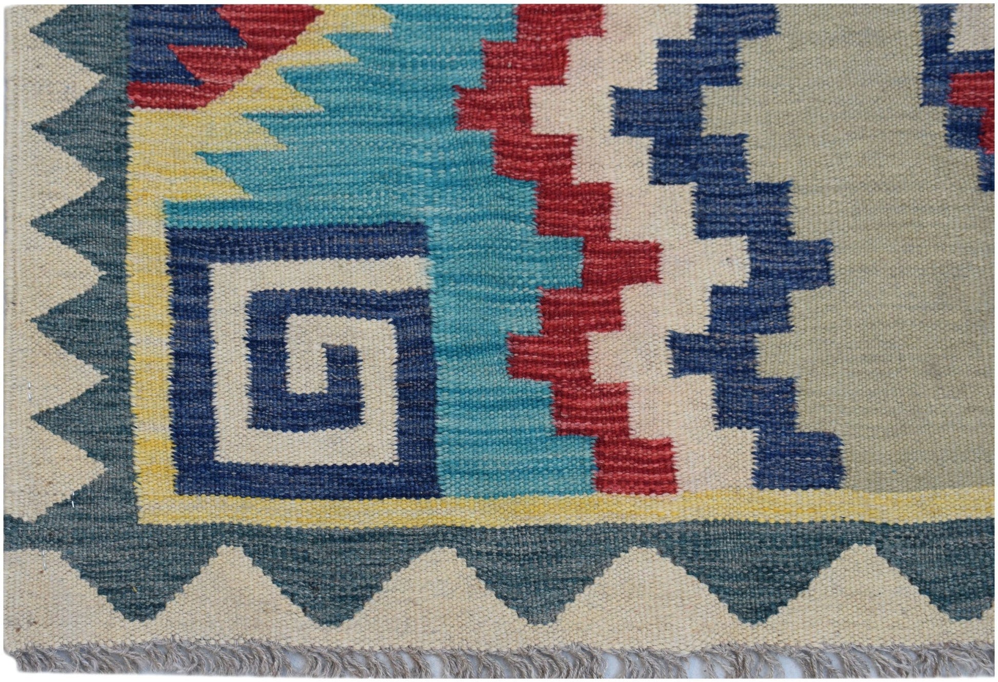 Handwoven Afghan Maimana kilim featuring a geometric pattern in blue, red, yellow, and cream.