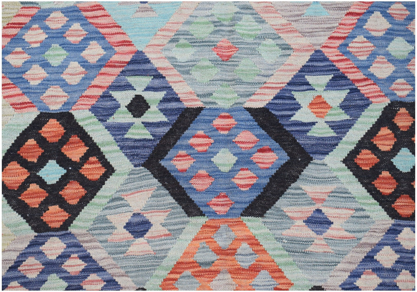Handwoven Afghan Maimana kilim featuring a geometric diamond pattern in vibrant multicolored wool.