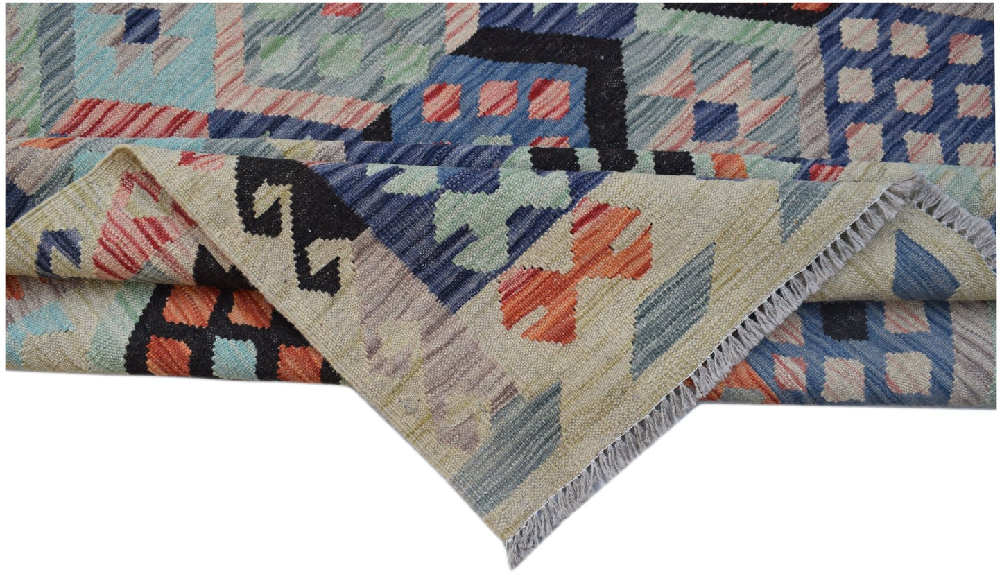 A handwoven Afghan Maimana kilim rug featuring a geometric pattern in blue, orange, and cream.