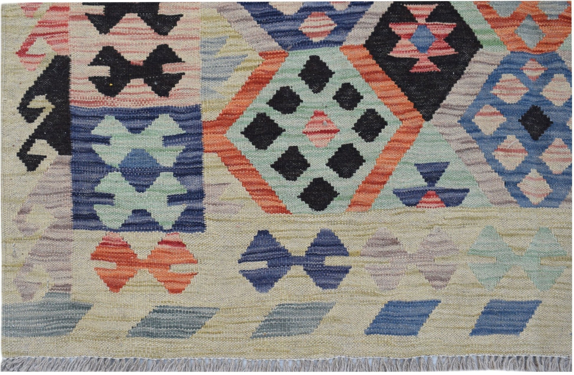 Handwoven Afghan Maimana kilim rug featuring a colorful geometric pattern on a flat wool weave.