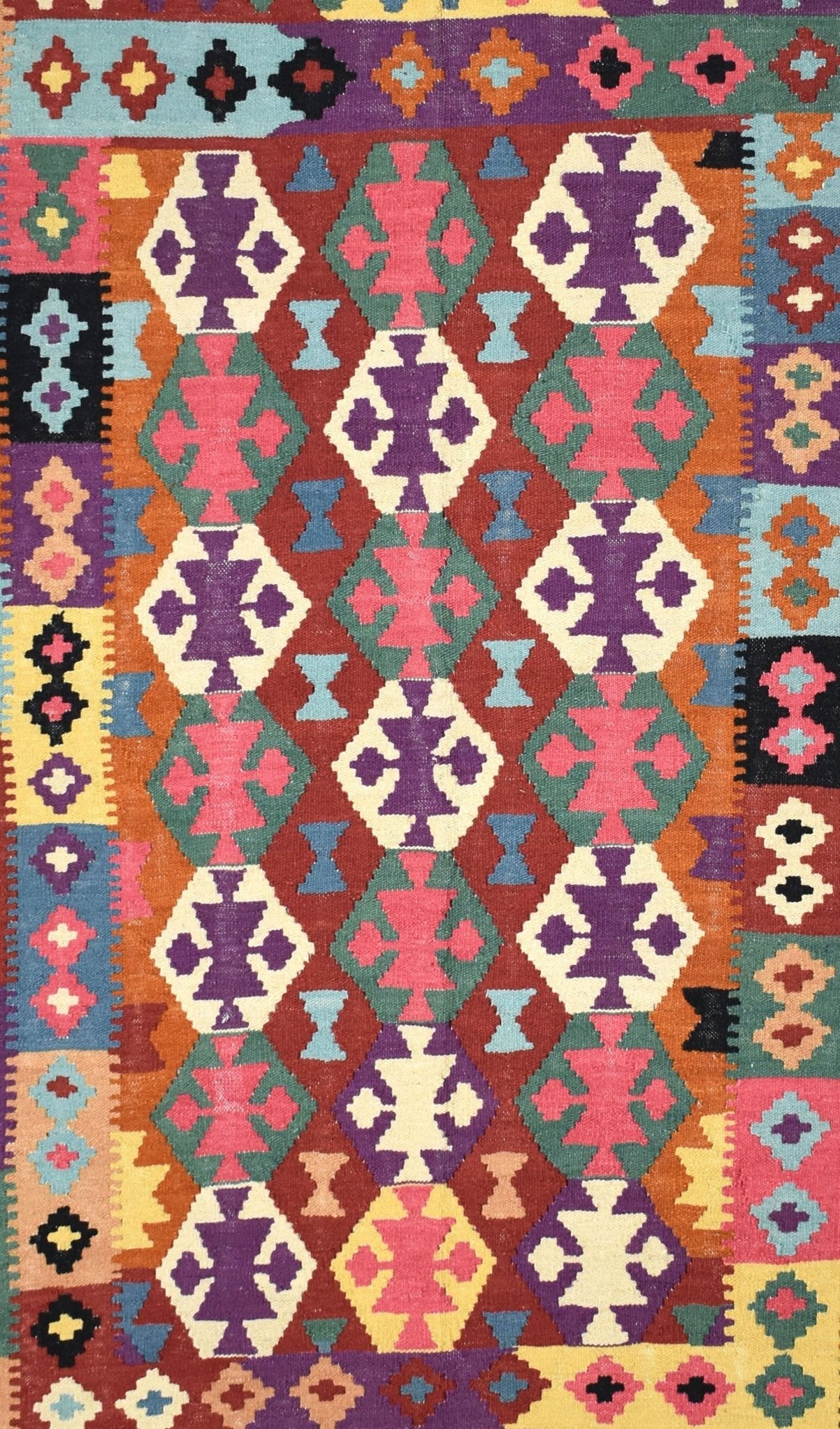 Handmade Afghan Maimana kilim rug featuring a vibrant geometric pattern in wool.