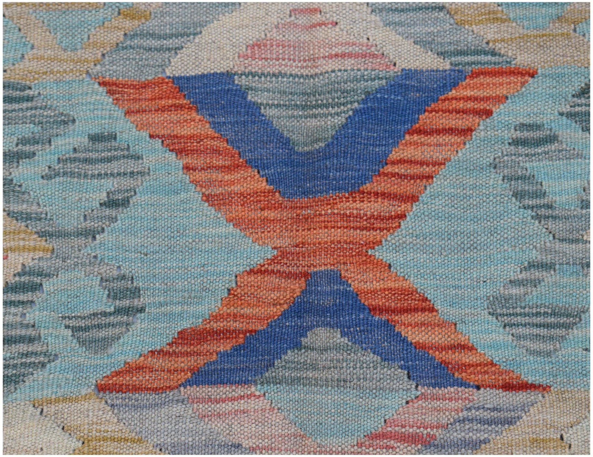 A handwoven Afghan Maimana kilim featuring a geometric pattern in blue, orange, and soft tones.