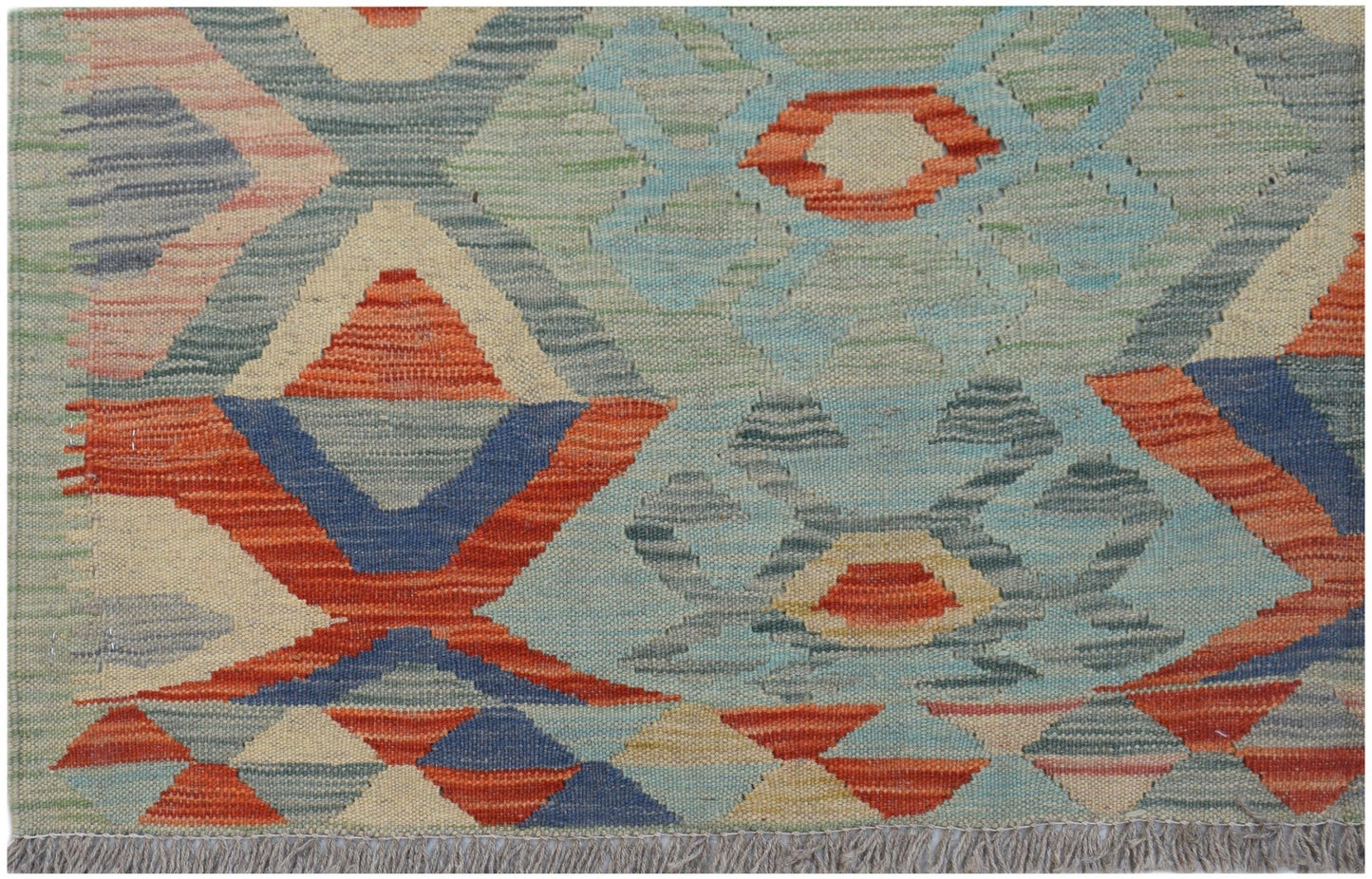 Handwoven Afghan Maimana kilim rug featuring a geometric pattern in blue, orange, and cream tones.