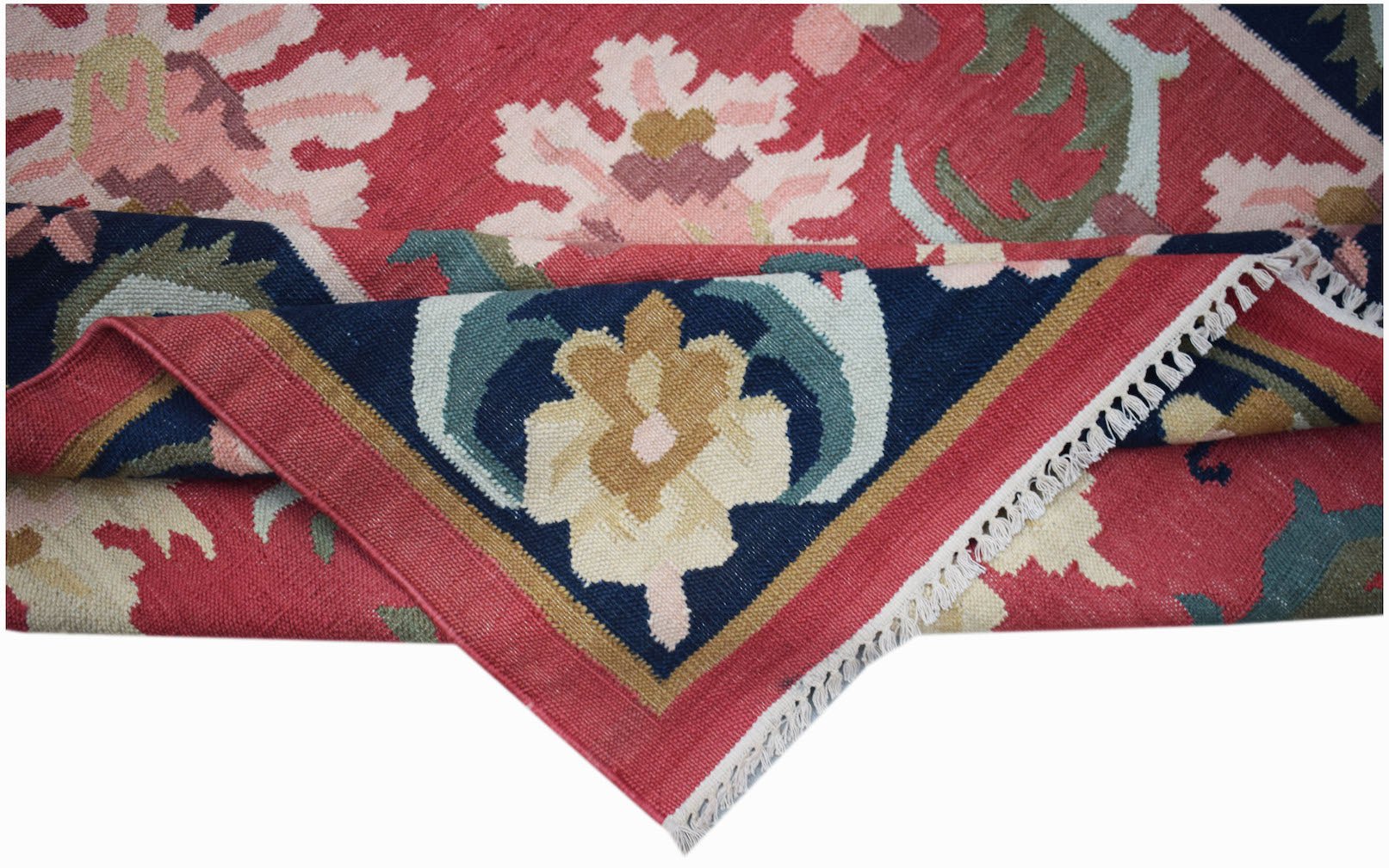 A handmade Afghan Maimana kilim rug featuring a floral pattern in red, blue, and cream tones.
