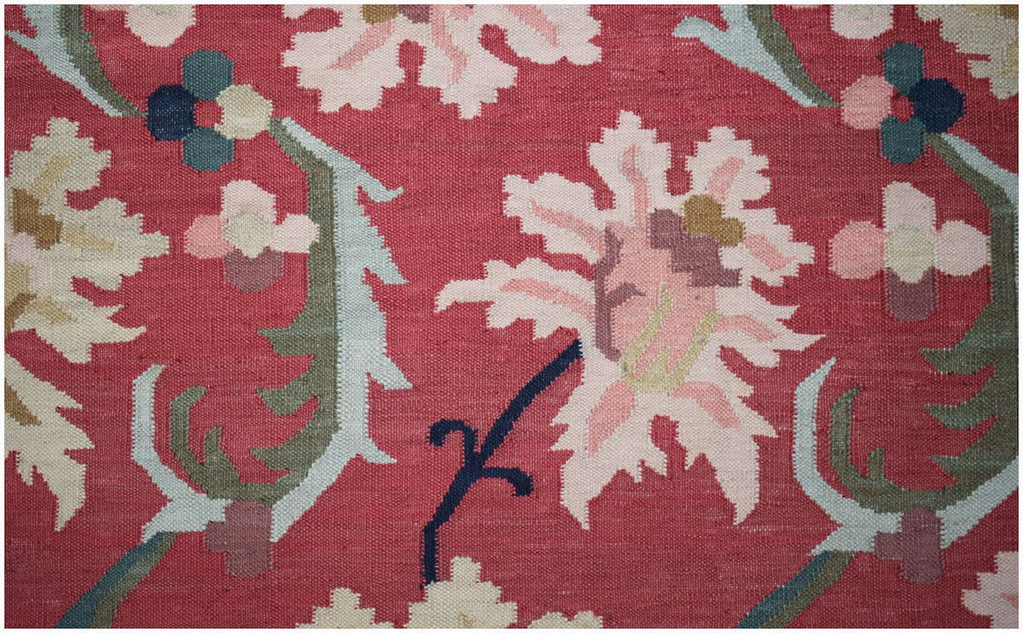 Handwoven Afghan Maimana kilim featuring a floral pattern in pink, green, and blue on a red base.