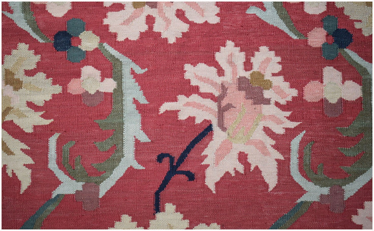 Handwoven Afghan Maimana kilim featuring a floral pattern in pink, green, and blue on a red base.