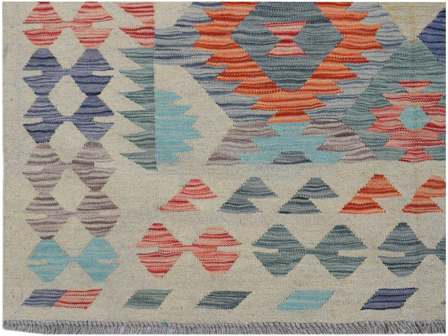 Handwoven Afghan Maimana kilim featuring geometric patterns in orange, blue, and grey wool.