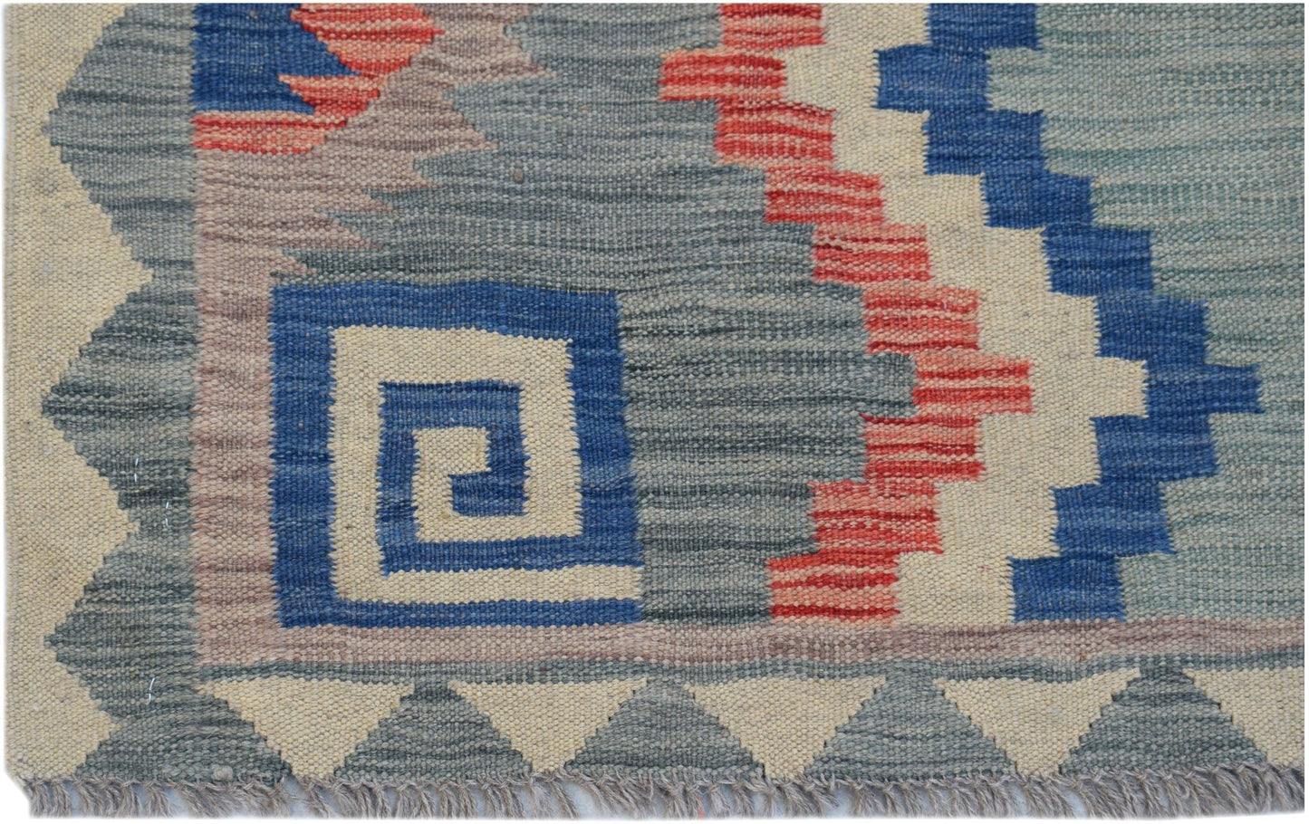 Handwoven Afghan Maimana kilim rug featuring a geometric pattern in blue, red, and cream wool.