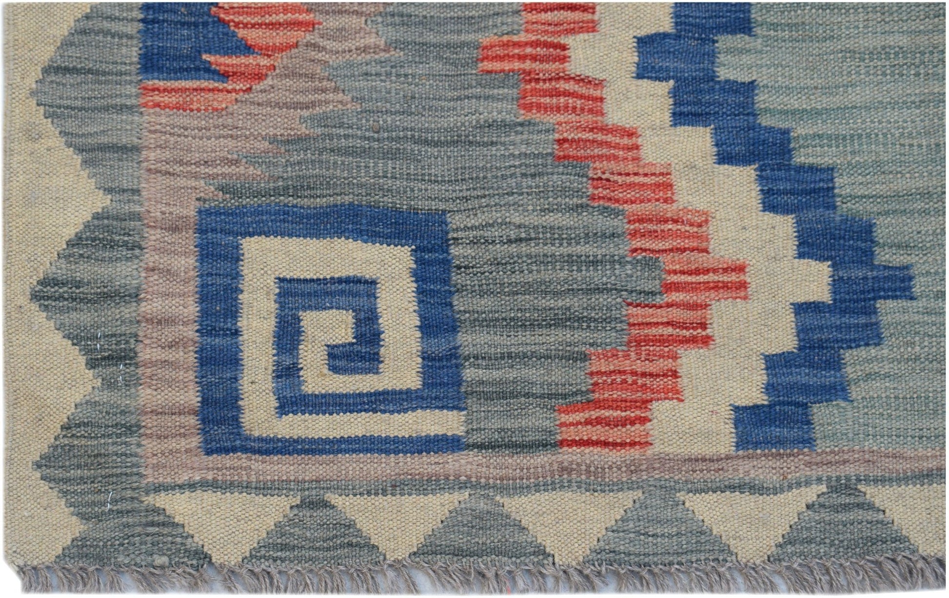 Handwoven Afghan Maimana kilim rug featuring a geometric pattern in blue, red, and cream wool.