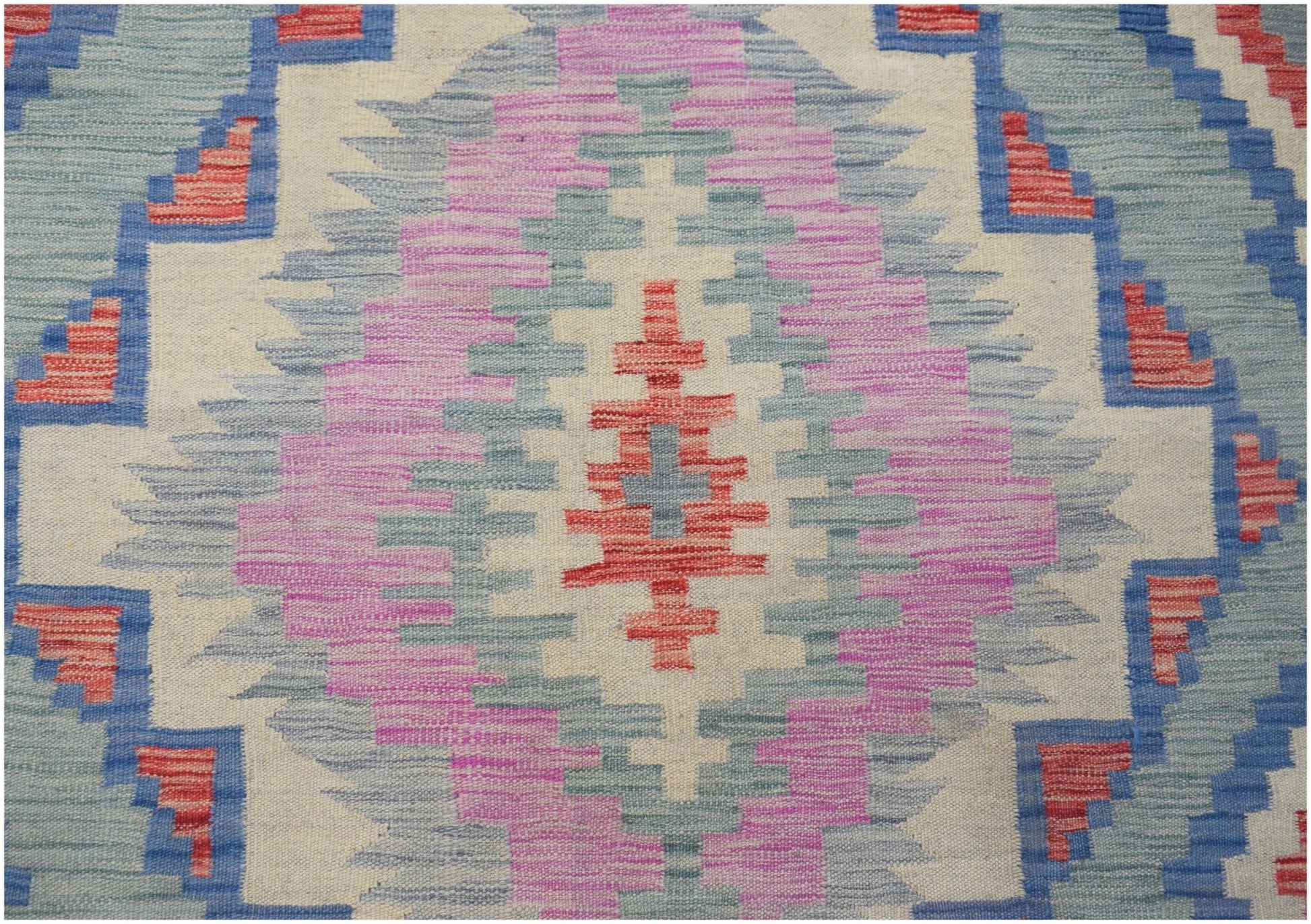 Handwoven Afghan Maimana kilim featuring a geometric diamond pattern in pink, blue, and red wool.