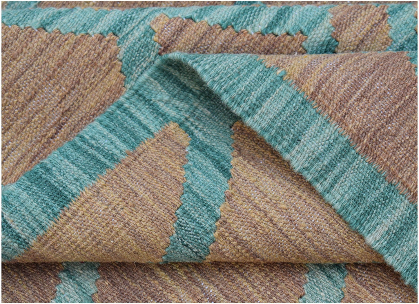 A handwoven Afghan Maimana kilim rug featuring a geometric pattern in shades of green and brown.
