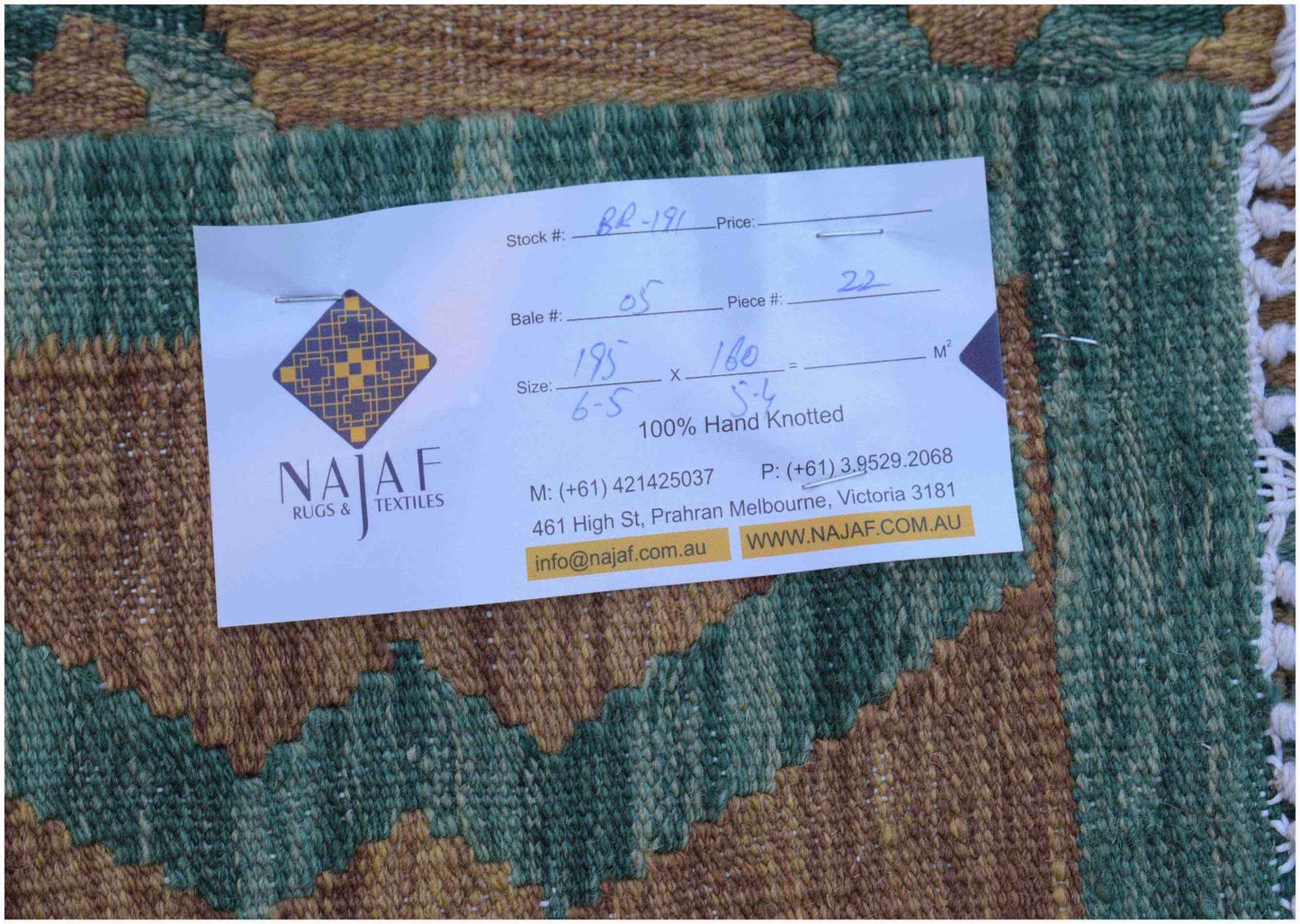 A handwoven Afghan Maimana kilim featuring a geometric pattern in shades of green and brown.