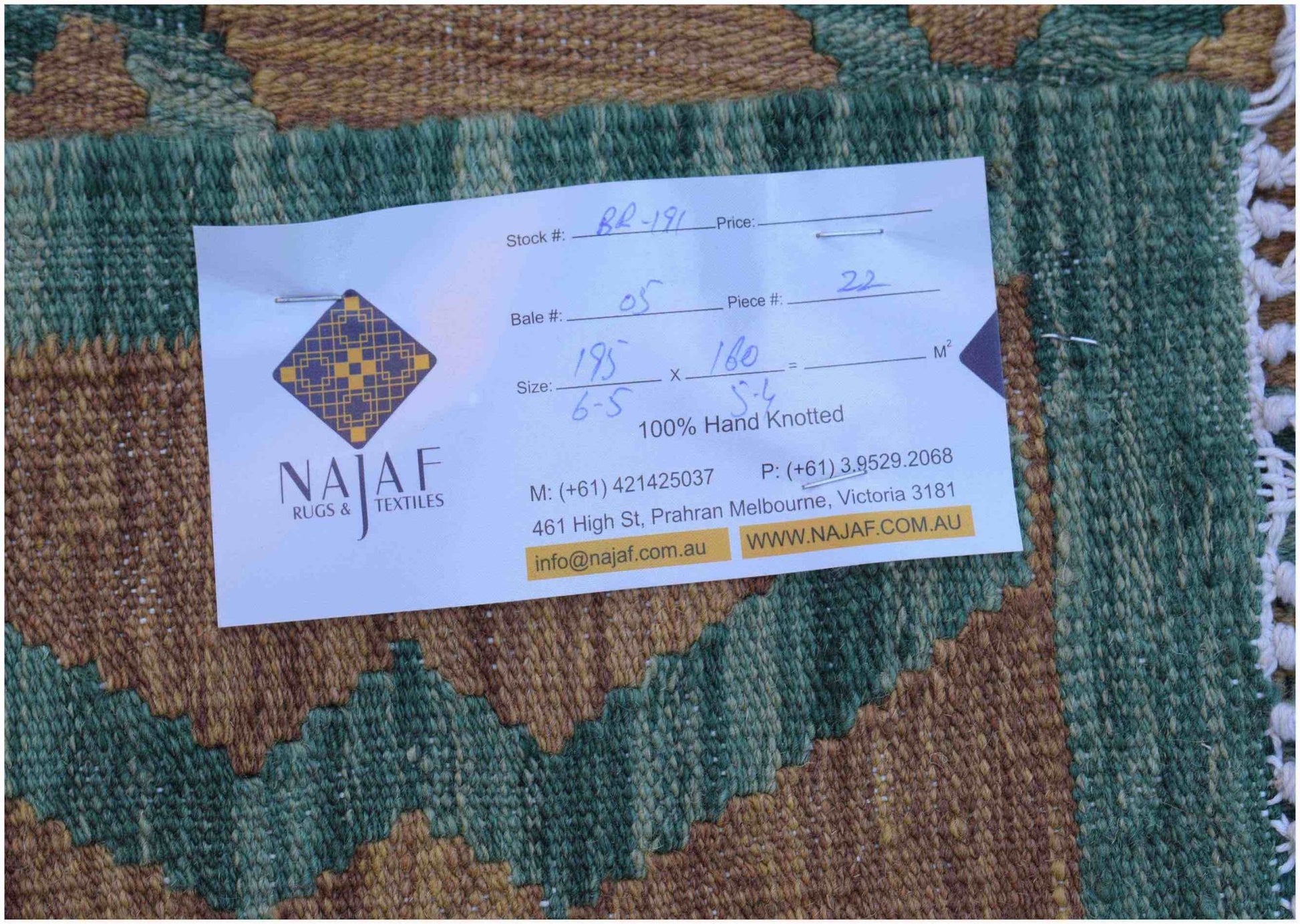 A handwoven Afghan Maimana kilim featuring a geometric pattern in shades of green and brown.