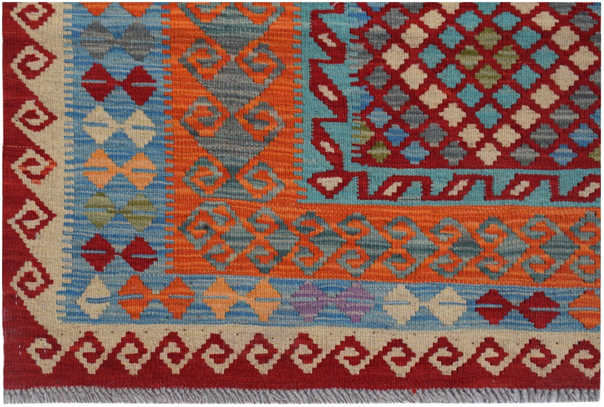 Handwoven Afghan Maimana kilim featuring a geometric pattern in vibrant red, orange, and blue.