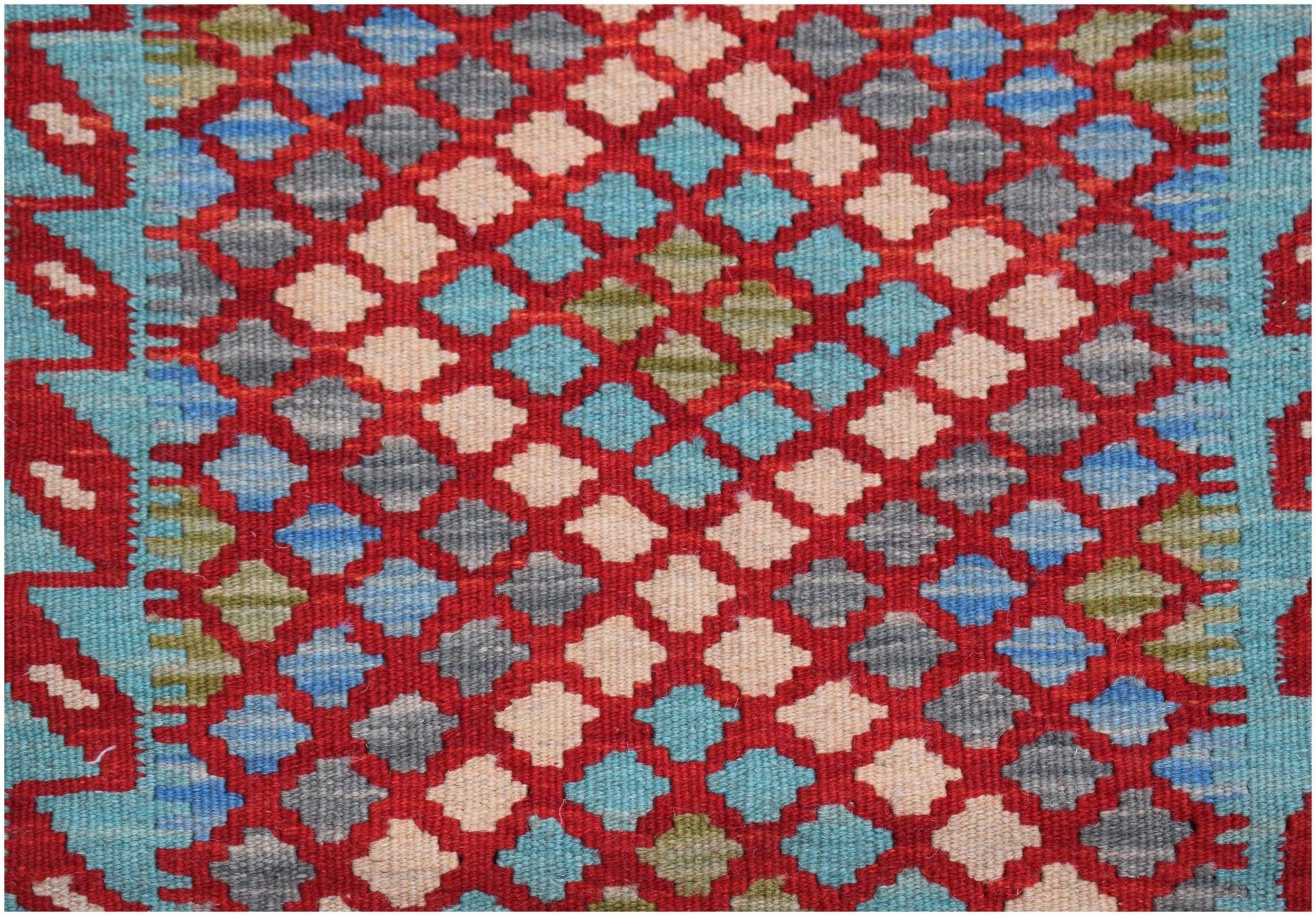 Handwoven Afghan Maimana kilim featuring a repeating geometric diamond pattern in red and blue.