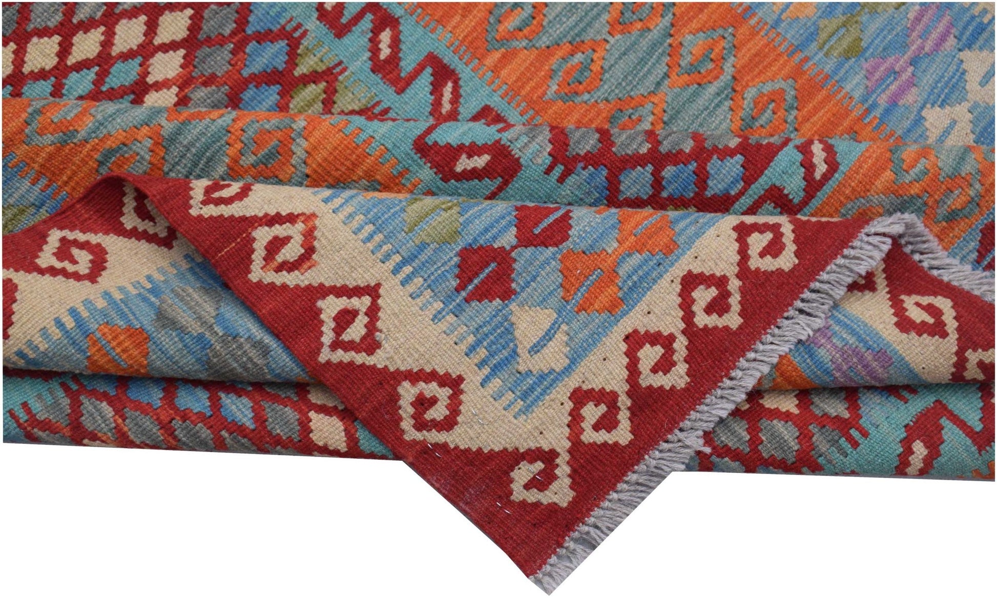 A handmade Afghan Maimana kilim rug featuring a geometric pattern in red, blue, and orange wool.