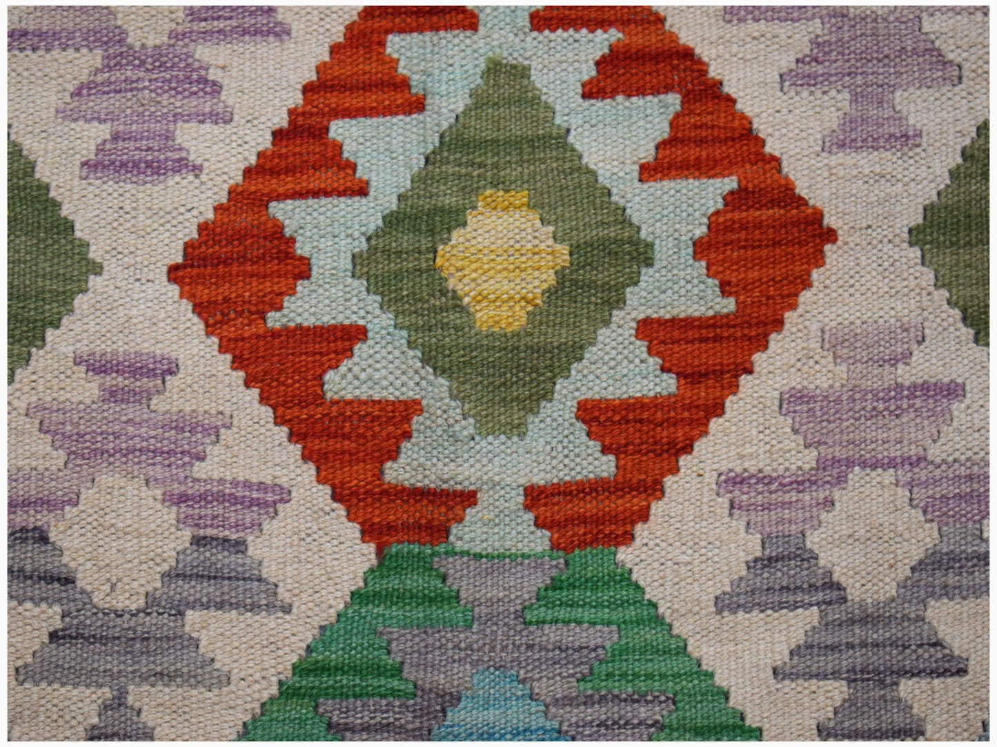 Afghan Maimana Kilim with geometric diamond patterns in red, green, yellow, and purple.