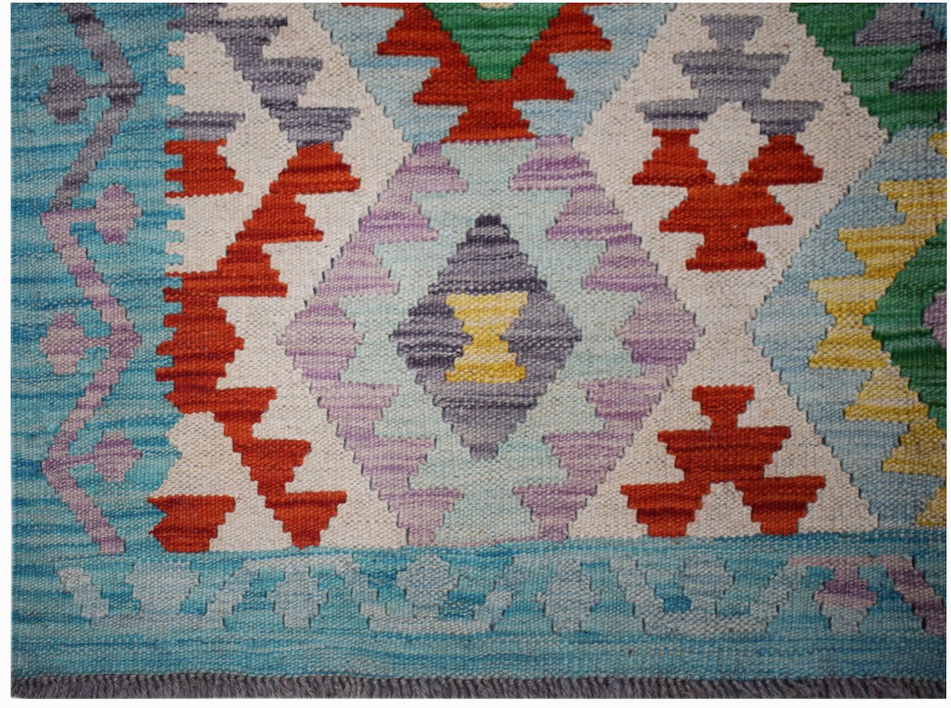 Handwoven Afghan Maimana kilim featuring a colorful geometric diamond pattern on a wool base.