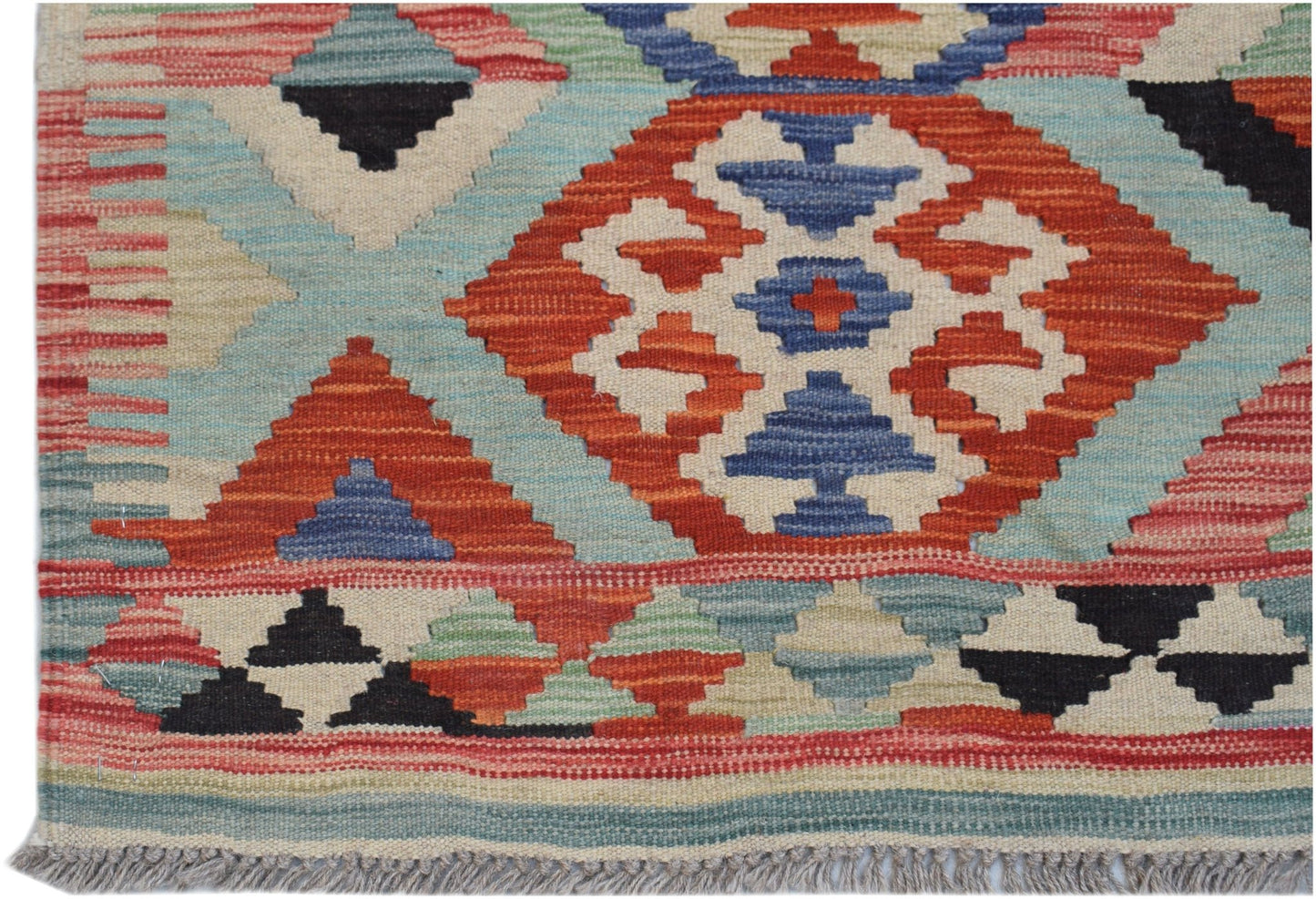 Handwoven Afghan Maimana kilim rug featuring geometric patterns in red, blue, and cream wool.