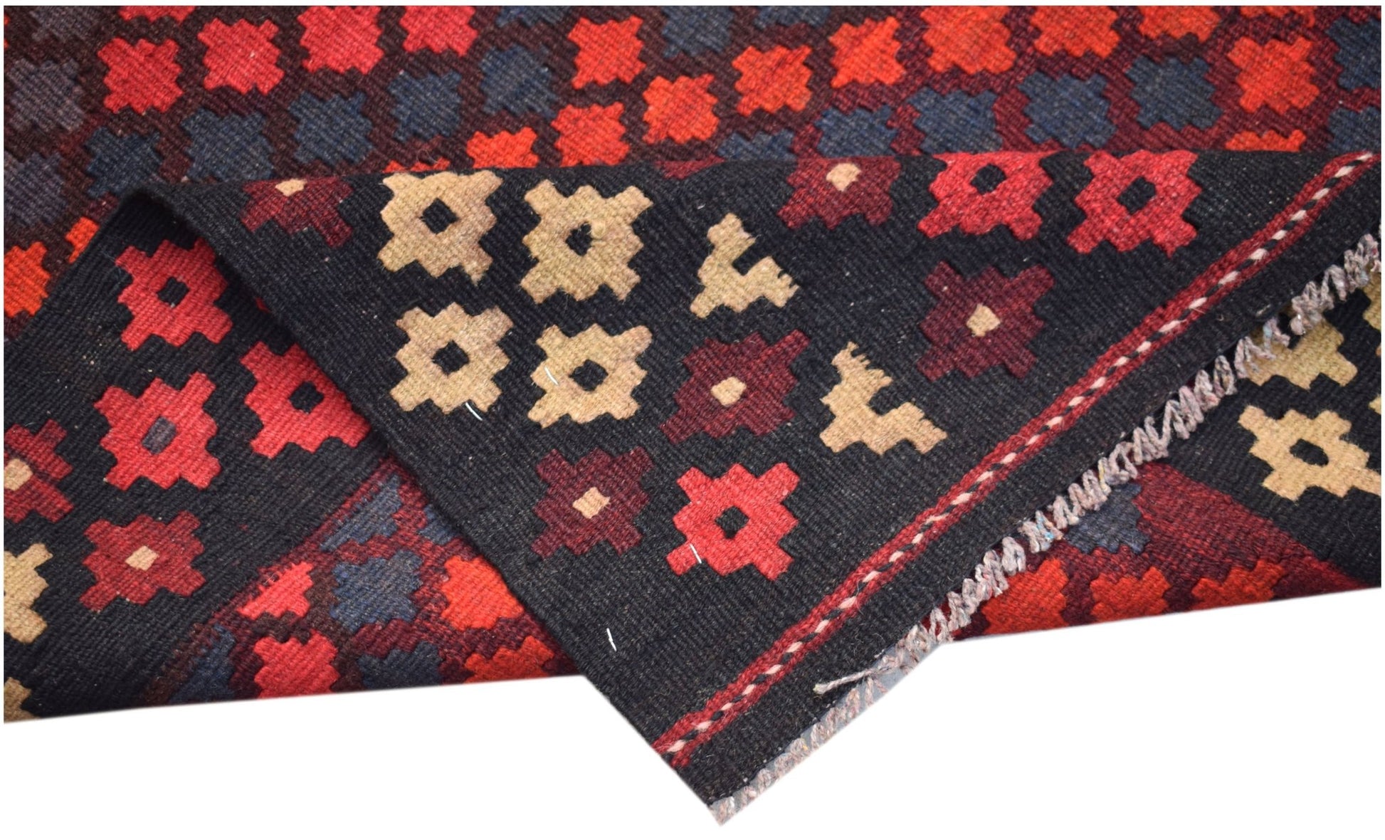 A handmade Afghan Maimana kilim featuring a geometric pattern in red, black, and beige wool.