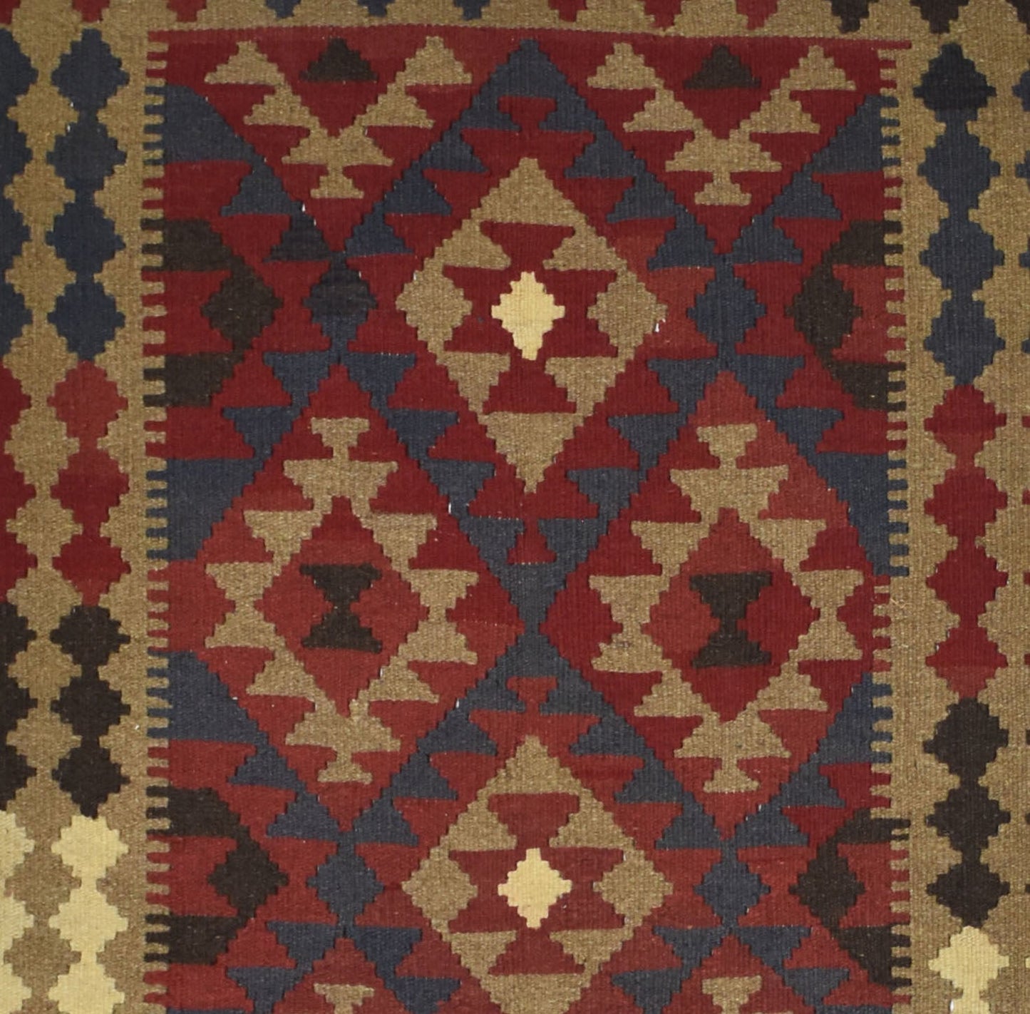 Handmade Afghan Maimana kilim rug featuring a geometric diamond pattern in red, blue, and tan.