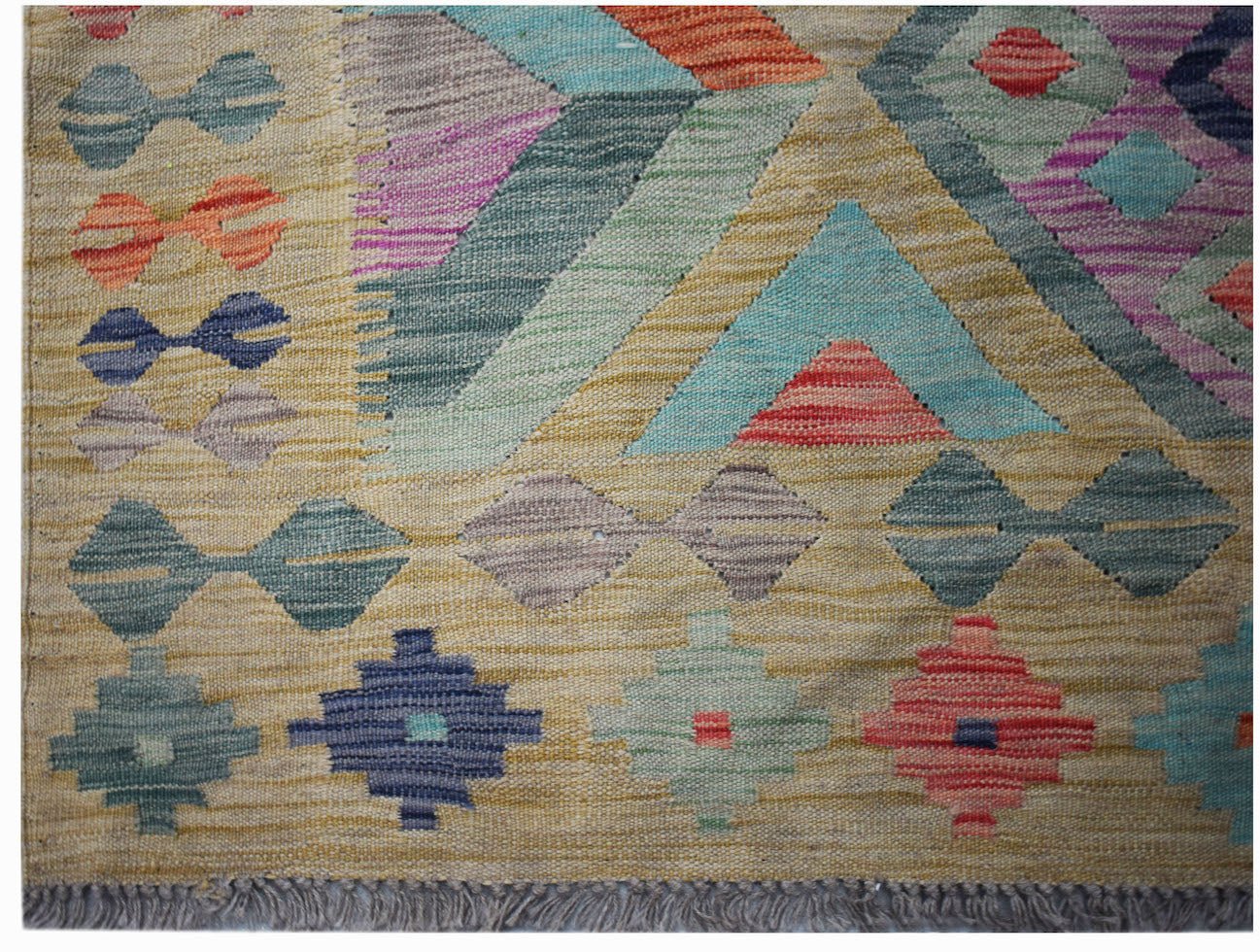Handwoven Afghan Maimana kilim featuring a geometric pattern in vibrant multicolored wool.
