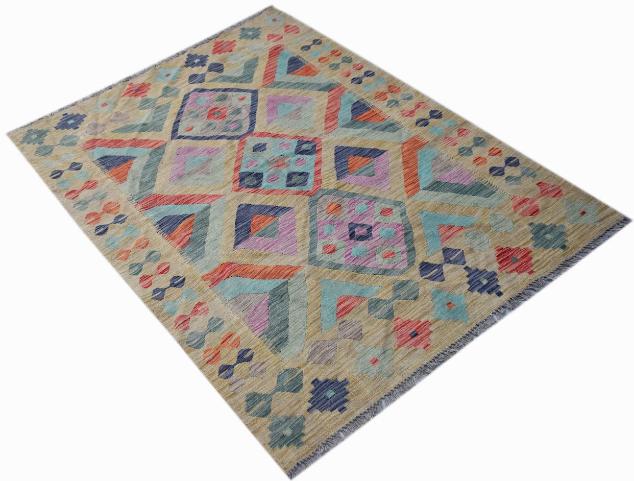 Handwoven Afghan Maimana kilim rug featuring a colorful geometric pattern on a tan background.