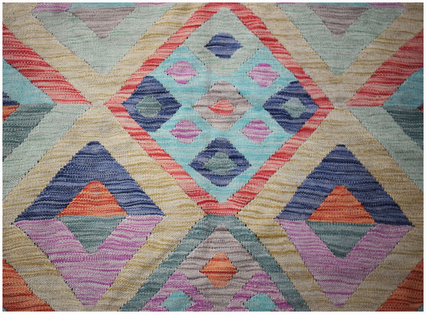 Handwoven Afghan Maimana kilim rug featuring a colorful geometric diamond pattern in wool.