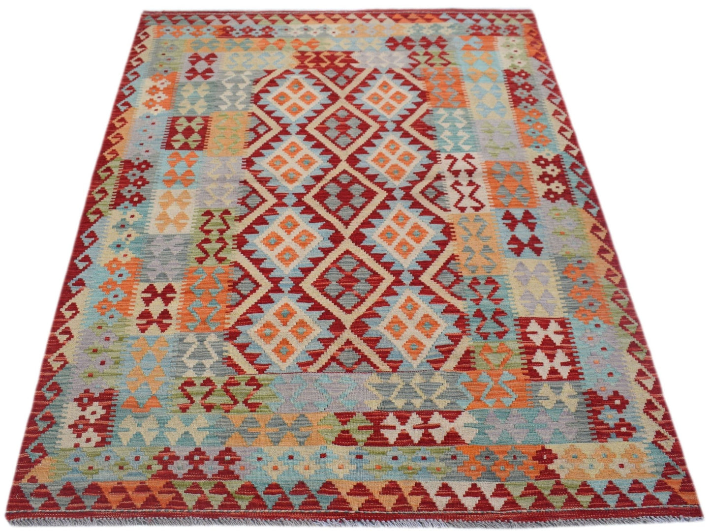 Handwoven Afghan Maimana kilim rug featuring a colorful geometric diamond pattern.
