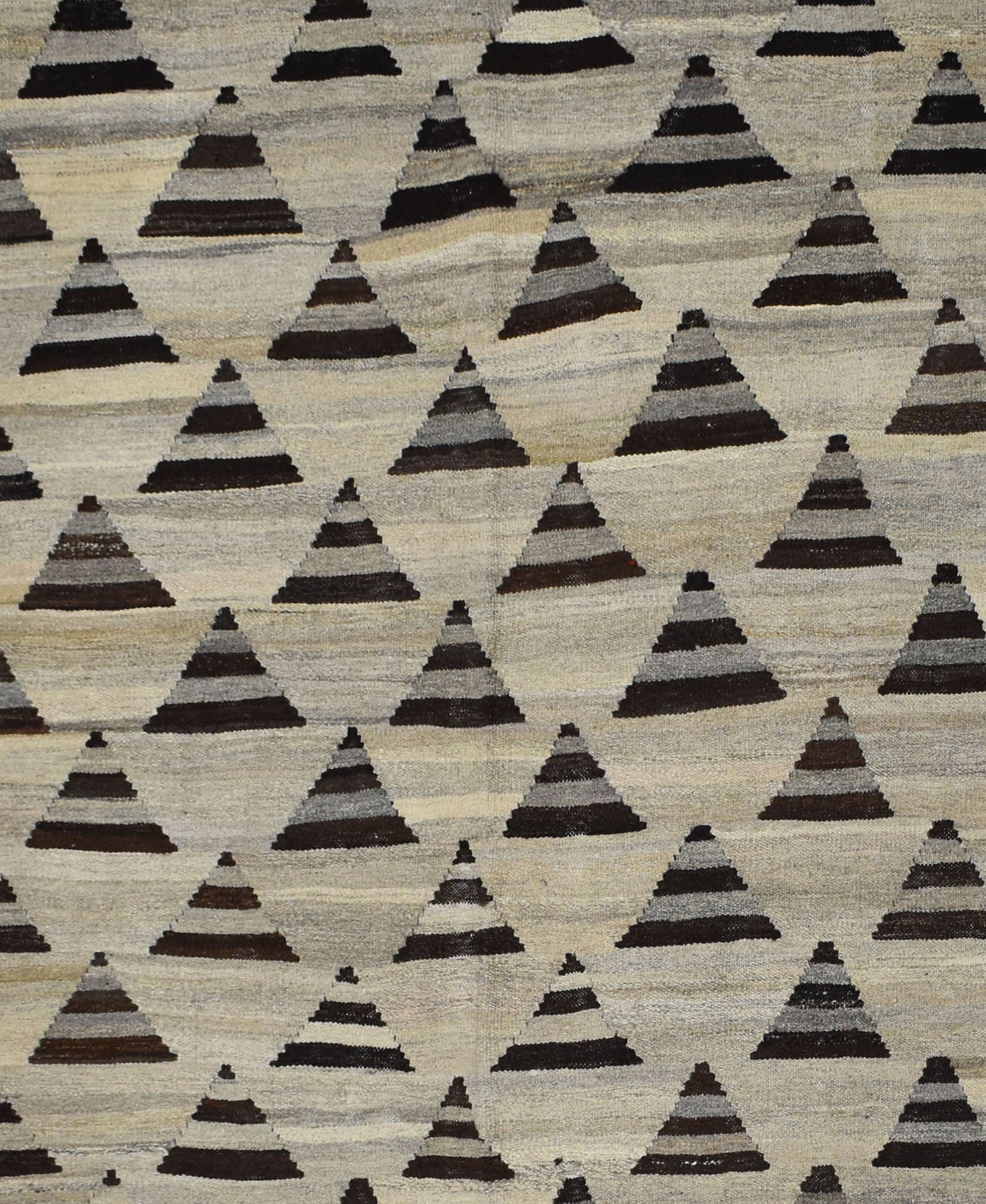 Handmade Afghan Maimana kilim rug featuring a repeating pattern of dark grey triangular motifs.