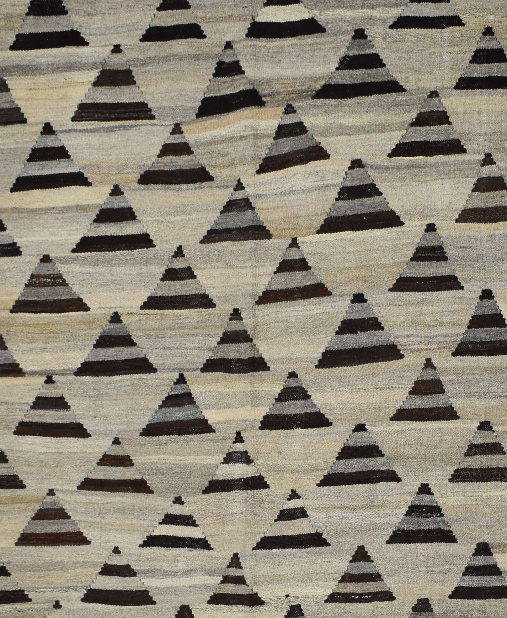 Handmade Afghan Maimana kilim rug featuring a repeating pattern of dark grey triangular motifs.