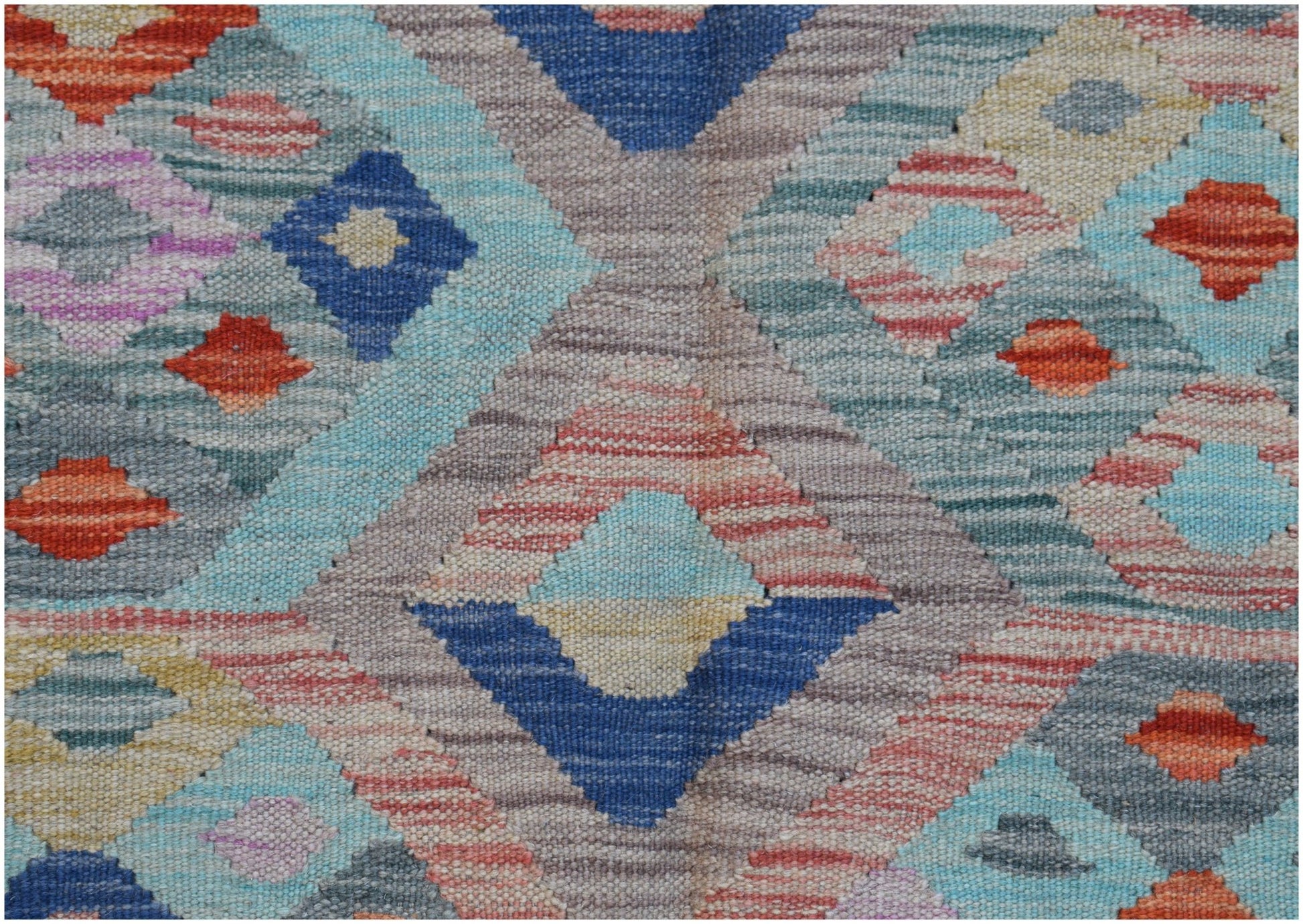 Handwoven Afghan Maimana kilim featuring a colorful geometric diamond pattern in wool.