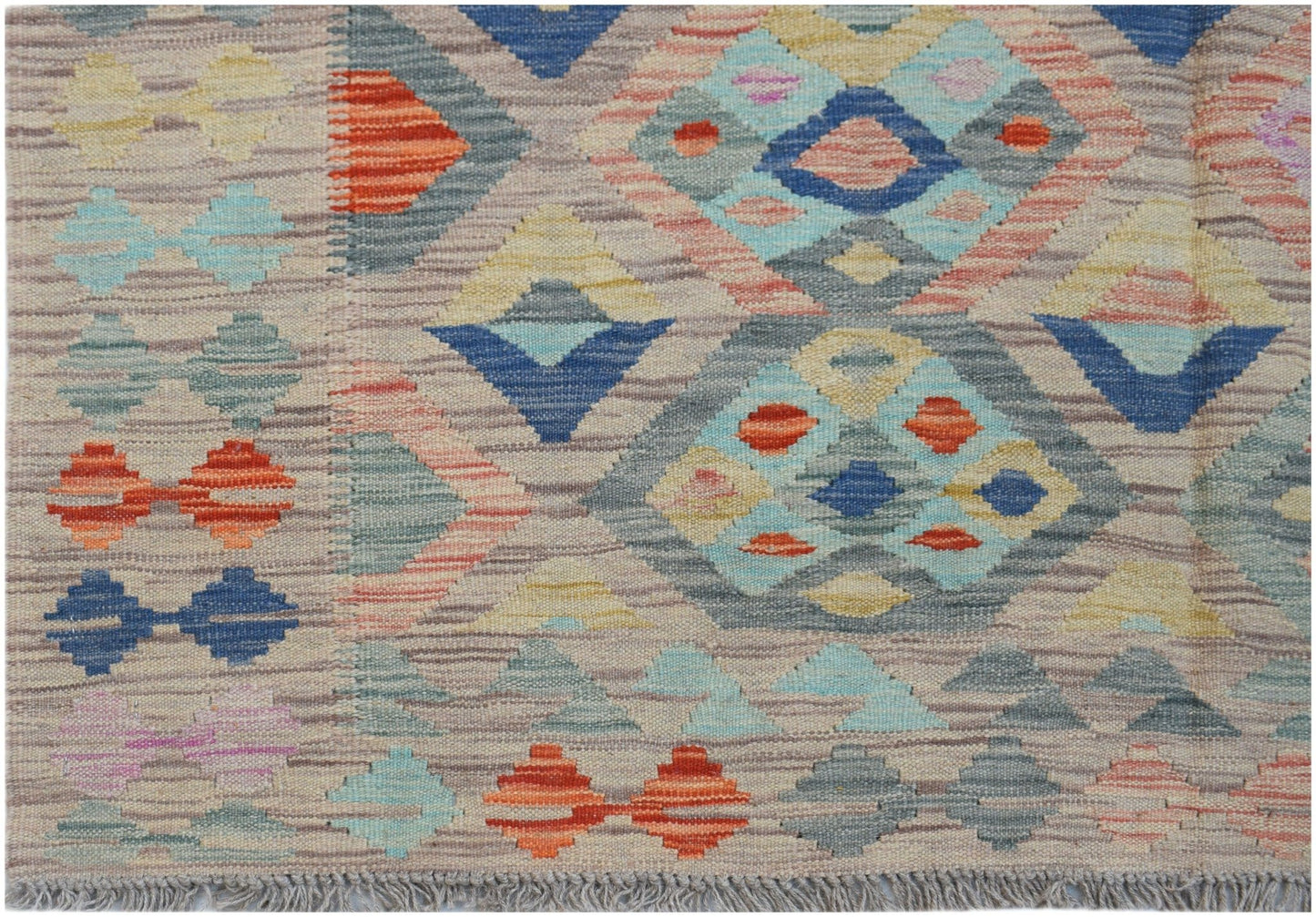 Handwoven Afghan Maimana kilim rug featuring a geometric diamond pattern in multicolored wool.
