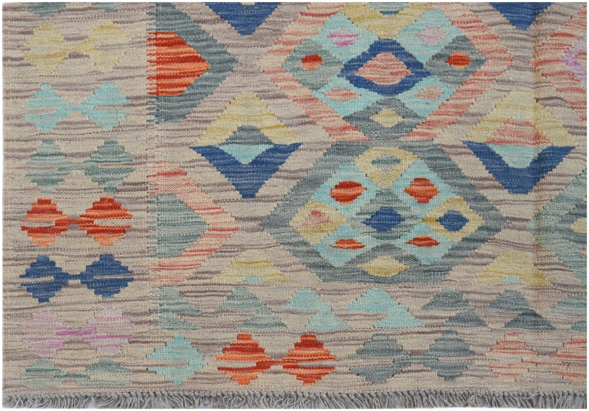 Handwoven Afghan Maimana kilim rug featuring a geometric diamond pattern in multicolored wool.