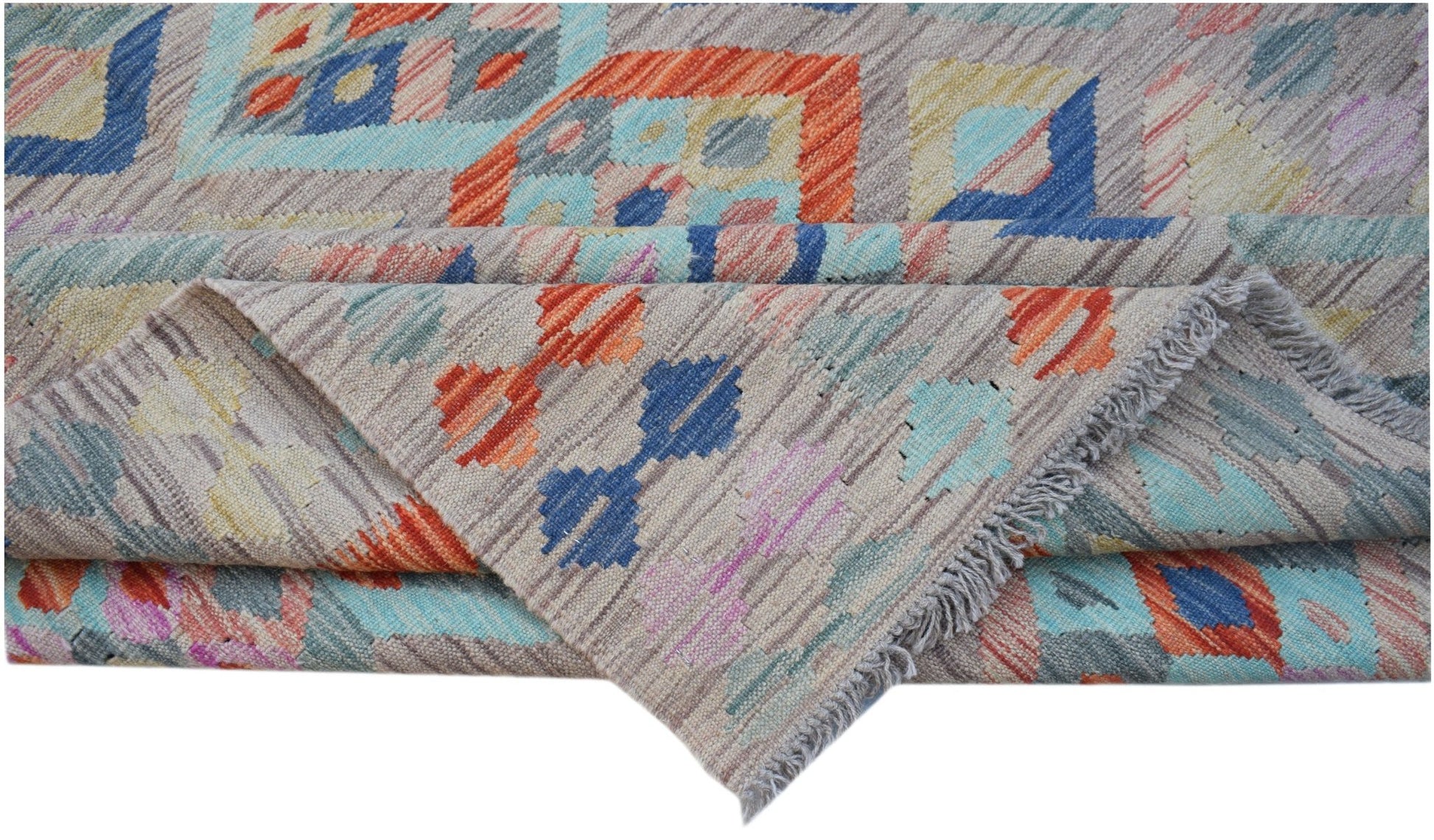 A handwoven Afghan Maimana kilim rug featuring a geometric pattern in vibrant multicolored wool.