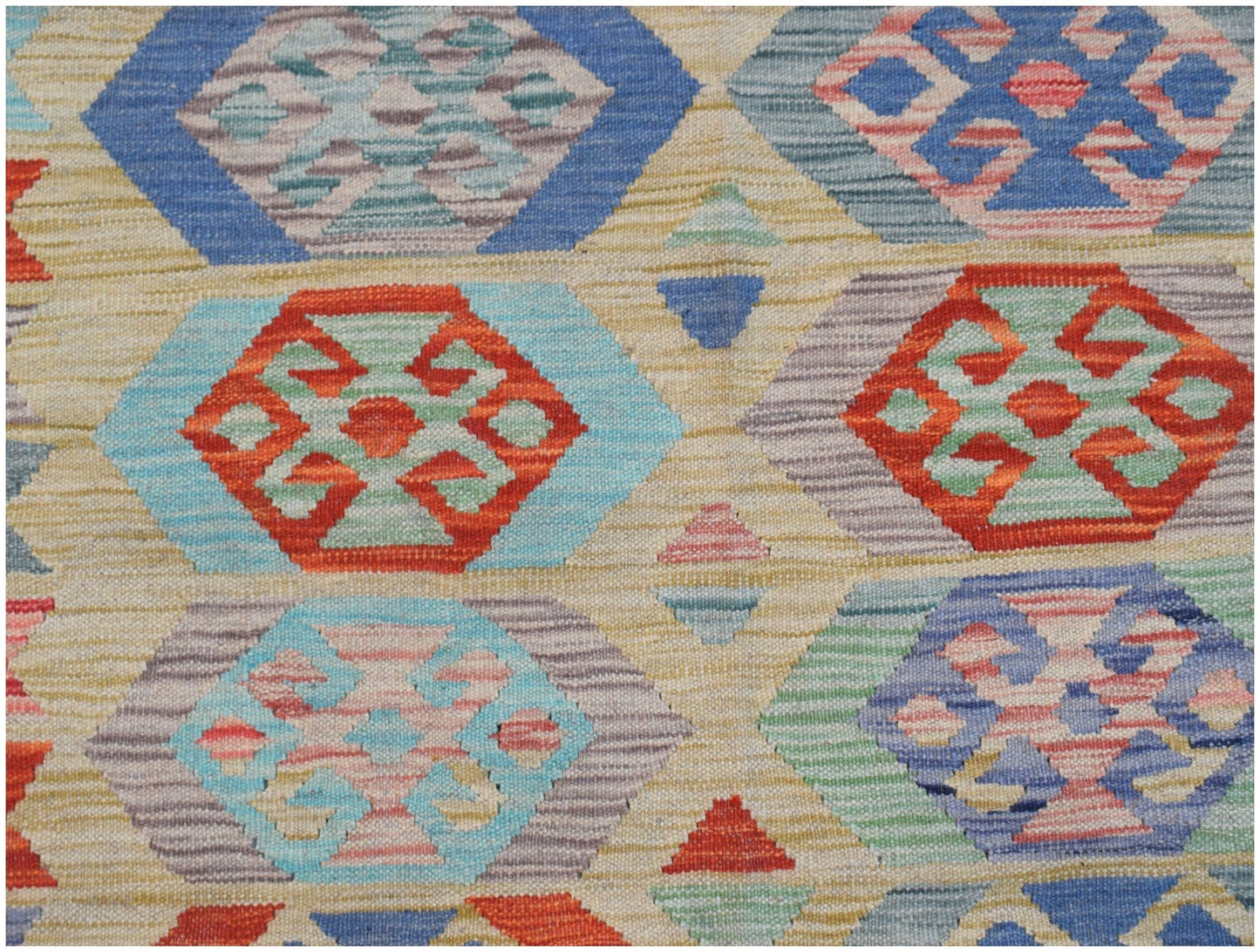 Handwoven Afghan Maimana kilim featuring a geometric pattern in vibrant multicolored wool.